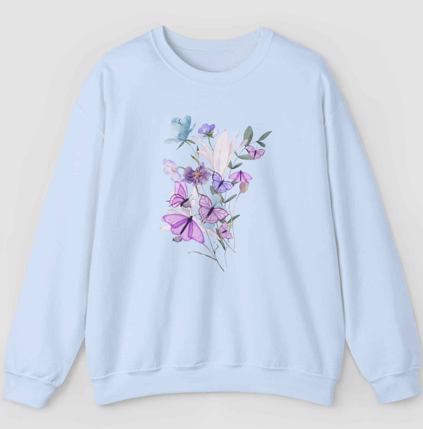 Light blue sweatshirt with colorful flower and butterfly graphics in a gray background