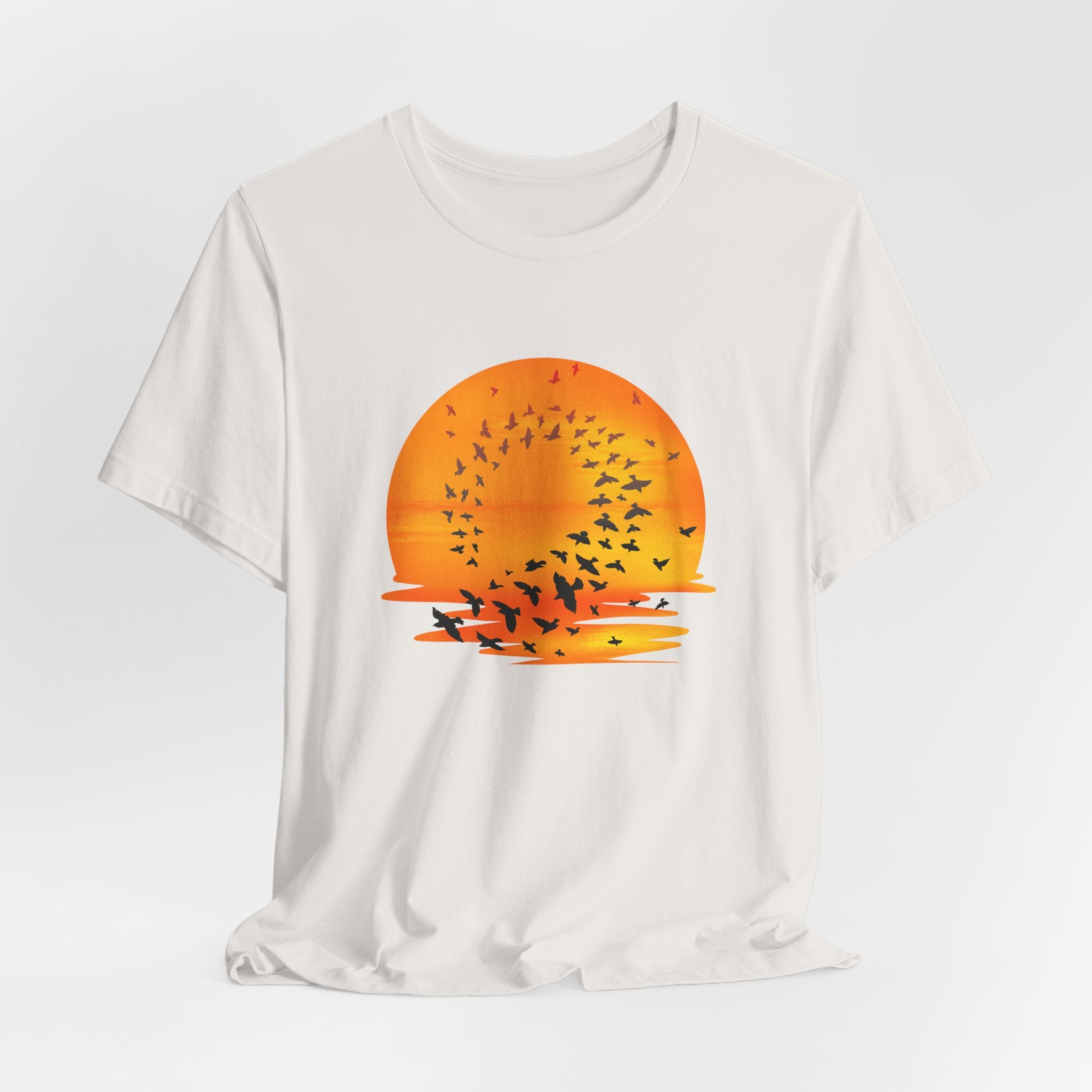 White t-shirt with a sunset and bird design on a white background