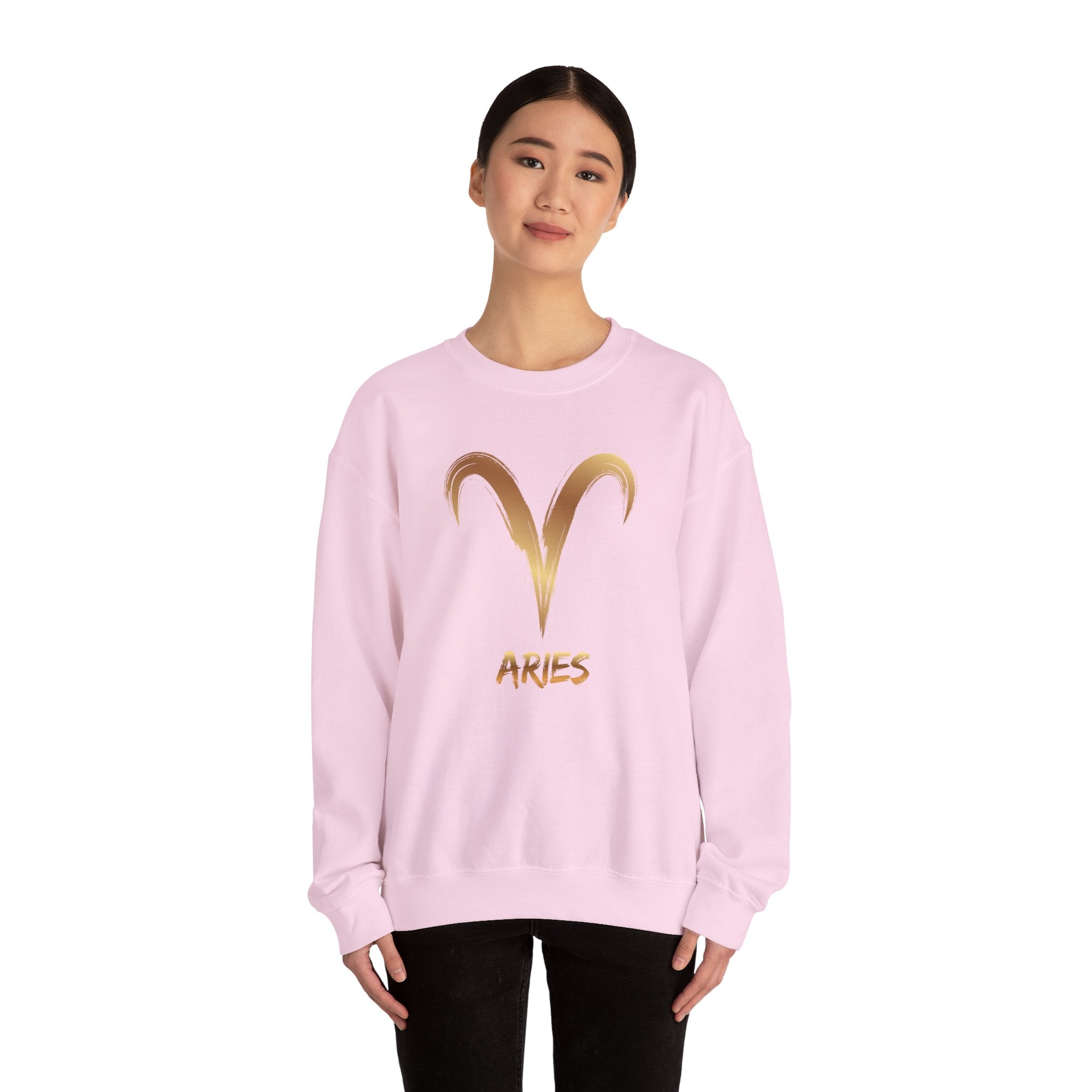 Pink sweatshirt with gold Aries symbol and text on a white background