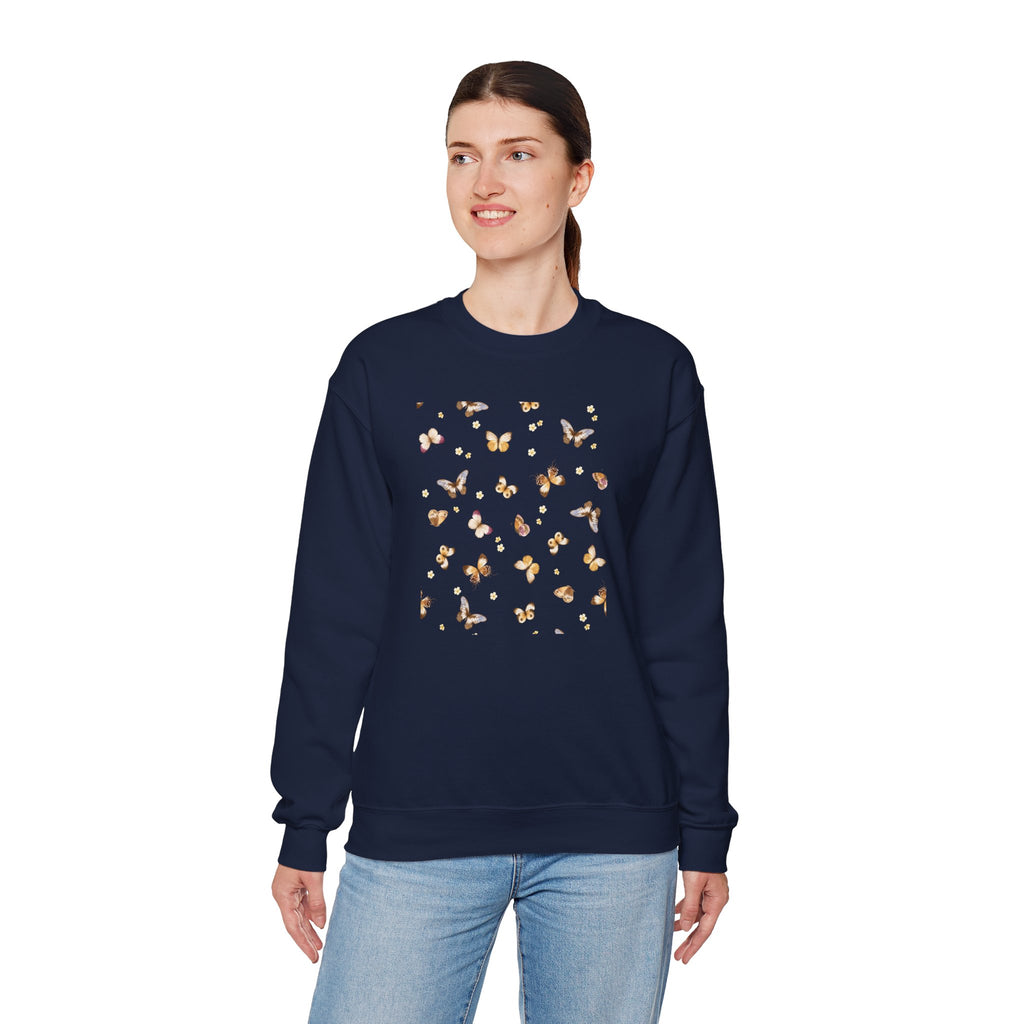 Person wearing a navy sweatshirt with a butterfly and flower design on a white background
