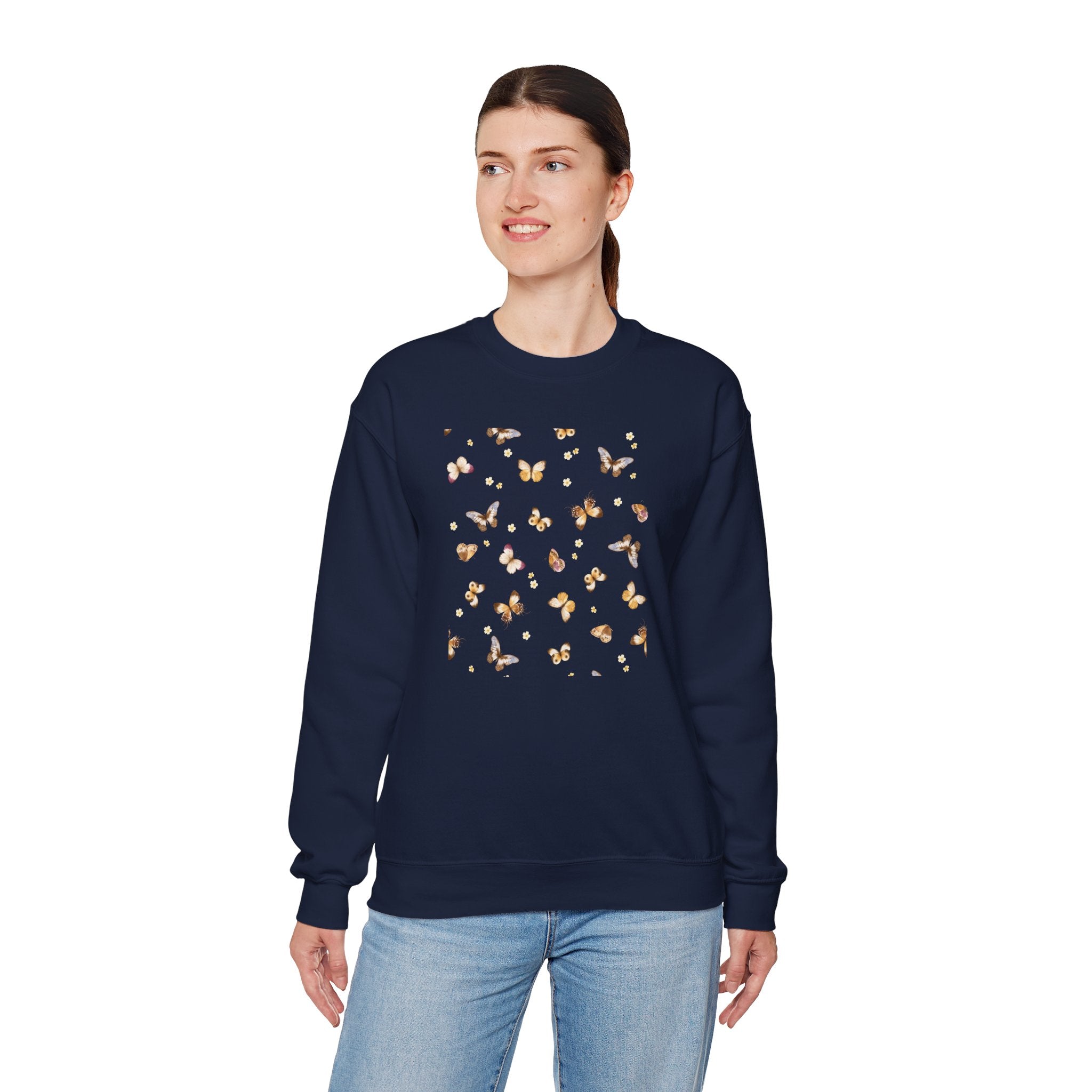 Person wearing a navy sweatshirt with a butterfly and flower design on a white background
