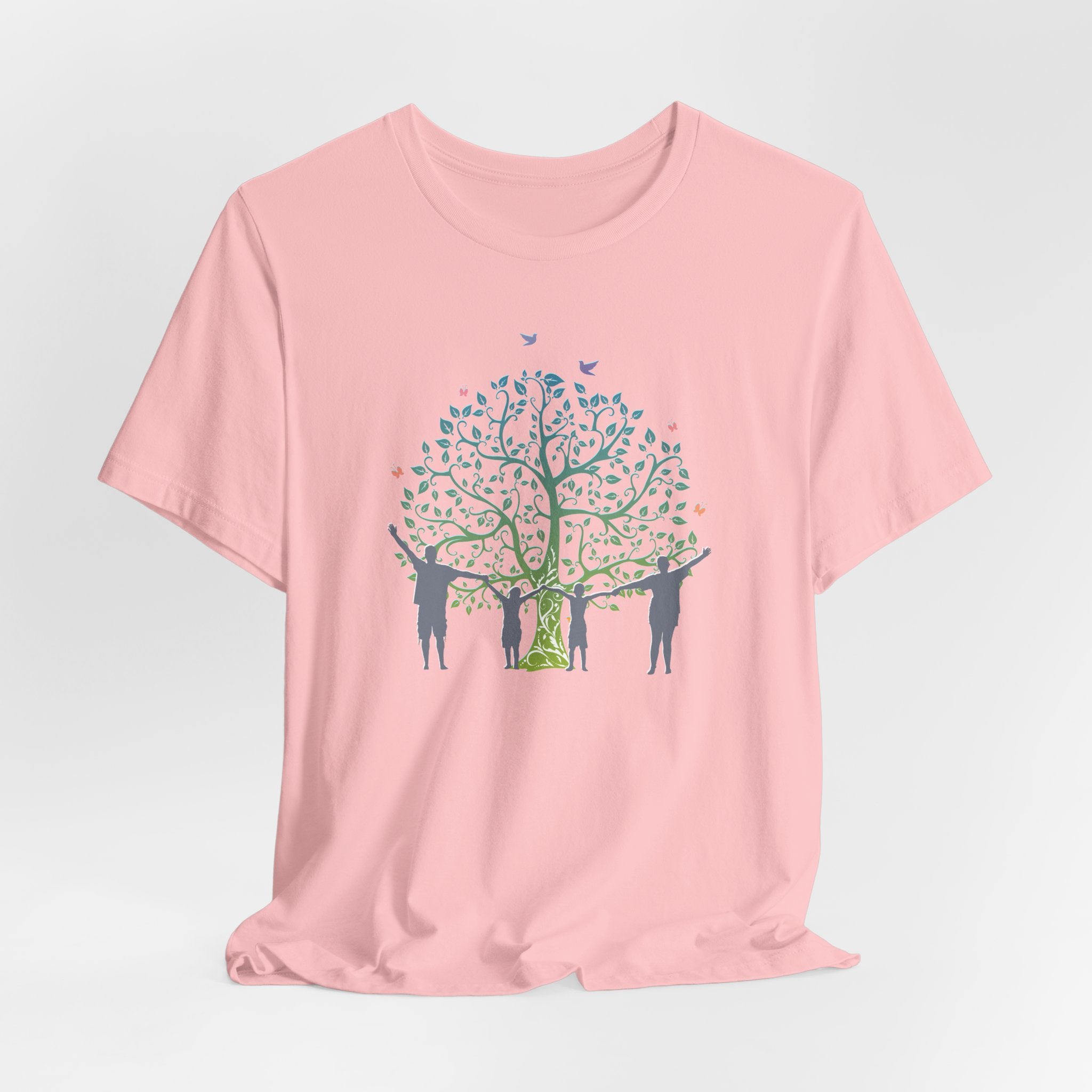 Pink t-shirt with a tree and people graphic on a light gray background
