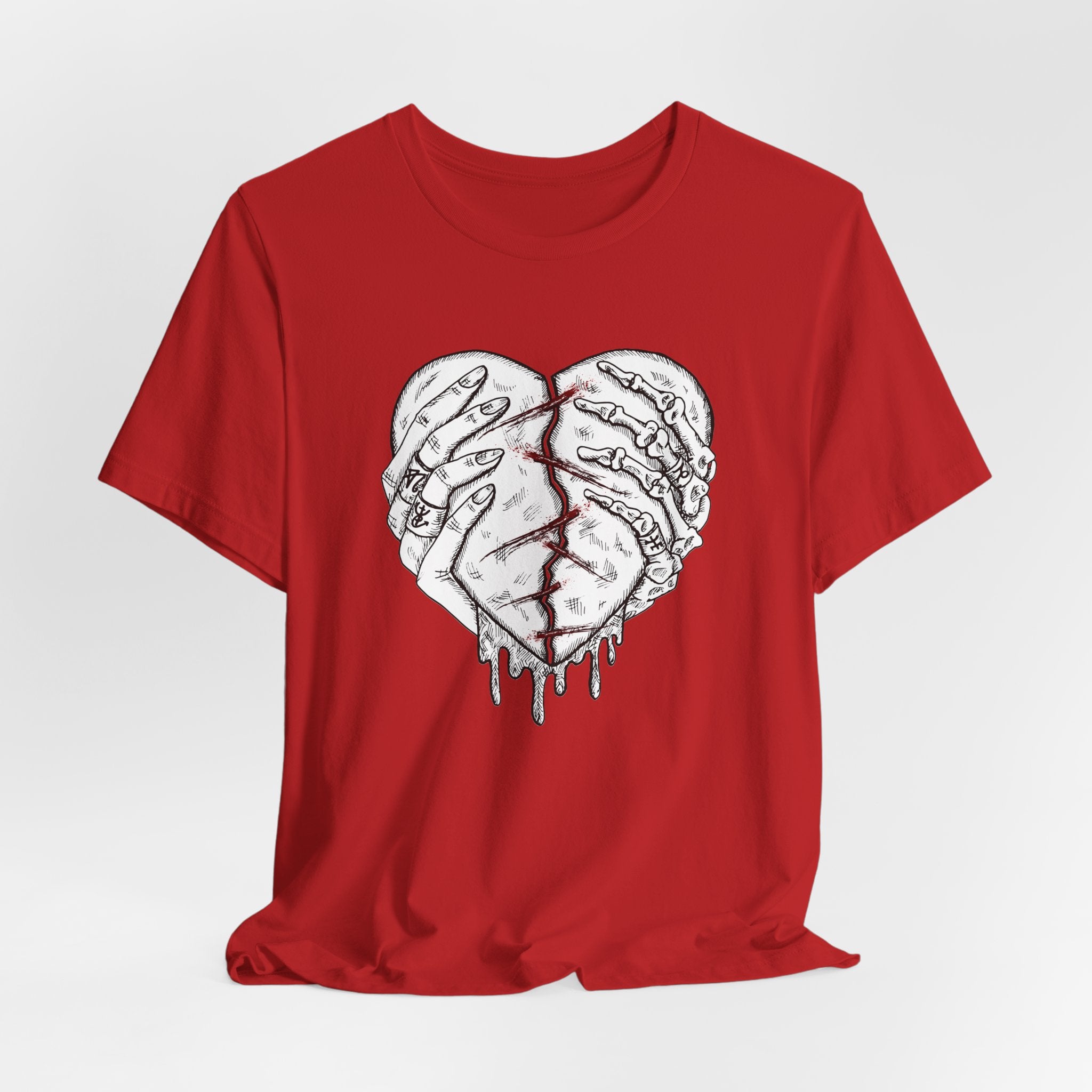 Red t-shirt with a graphic design of two hands holding a heart on a white background