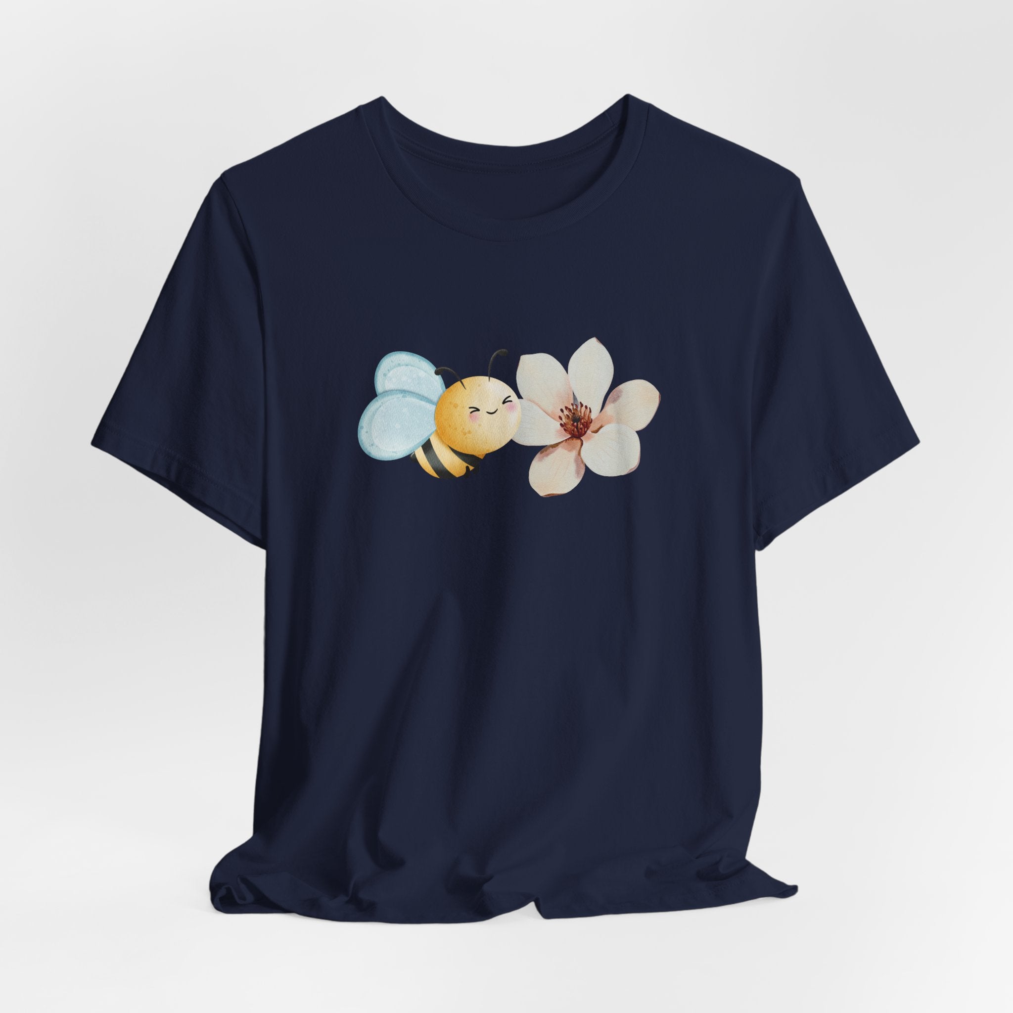 Navy blue t-shirt with a bee and flower design on a light gray background