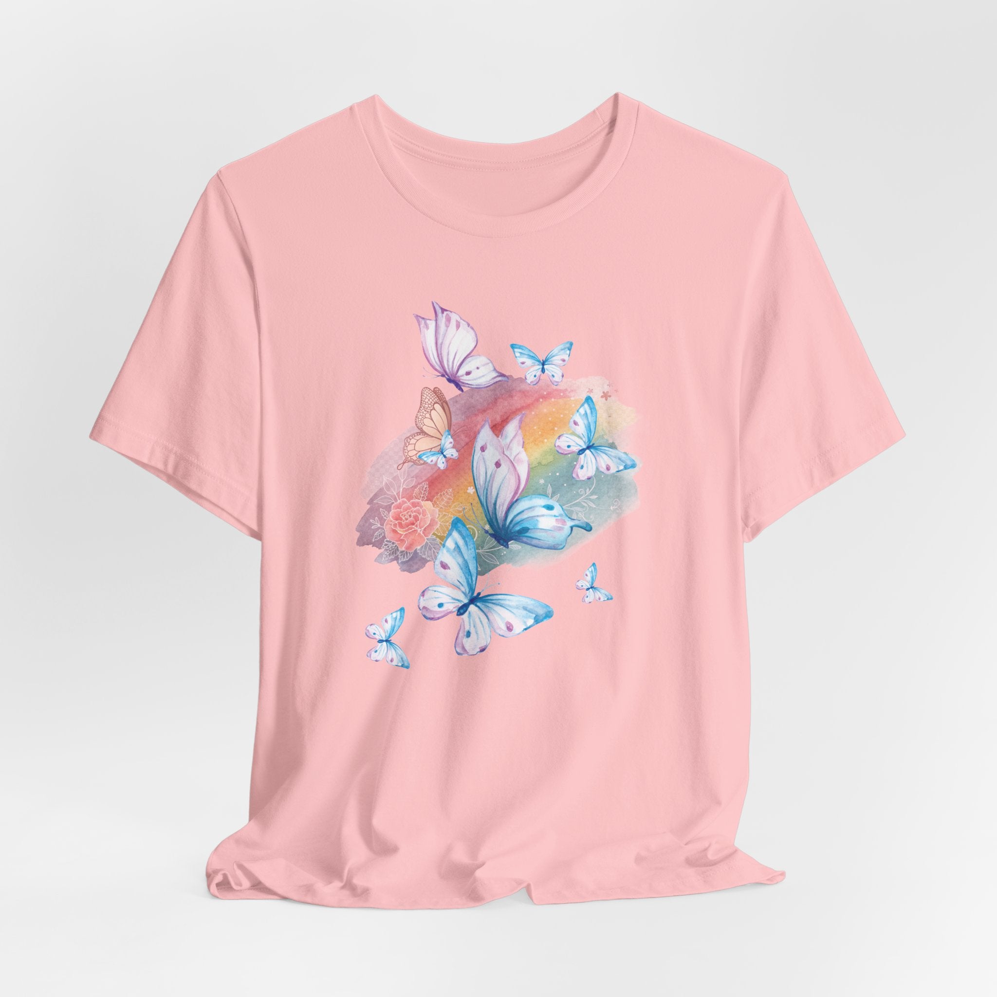 Pink t-shirt with butterfly design on a light gray background