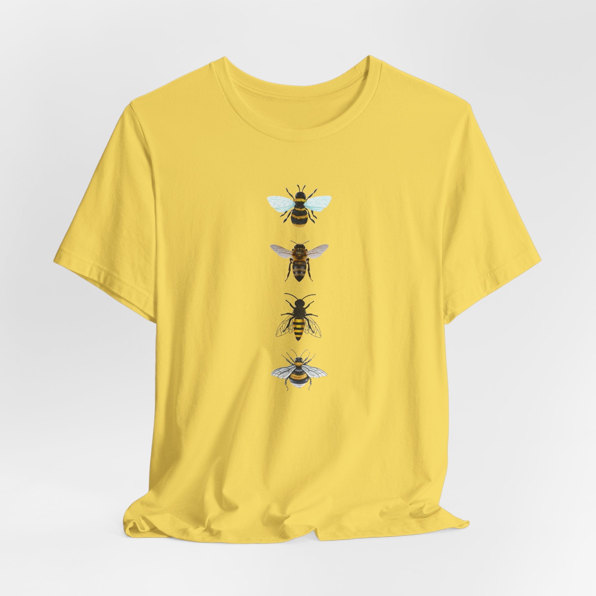 Yellow t-shirt with bee illustrations on a light gray background