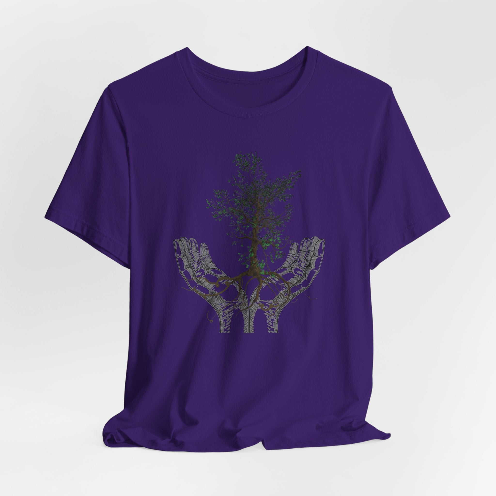Purple t-shirt with a graphic design of hands holding a tree on a white background