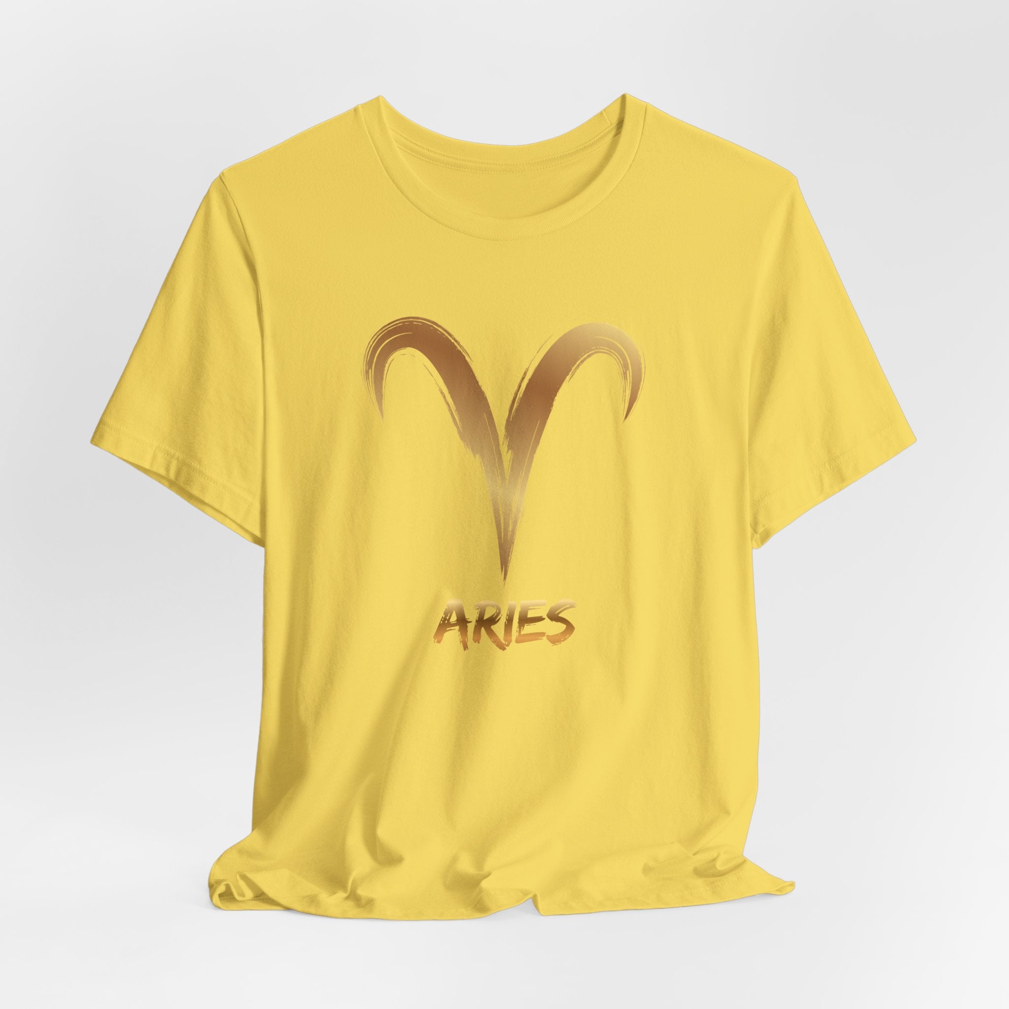 Yellow t-shirt with Aries symbol and text on a light gray background