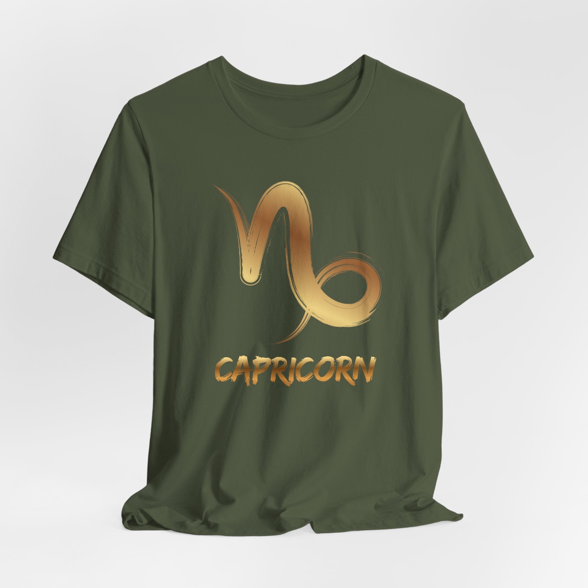 Green t-shirt with Capricorn zodiac symbol in gold on a light gray background