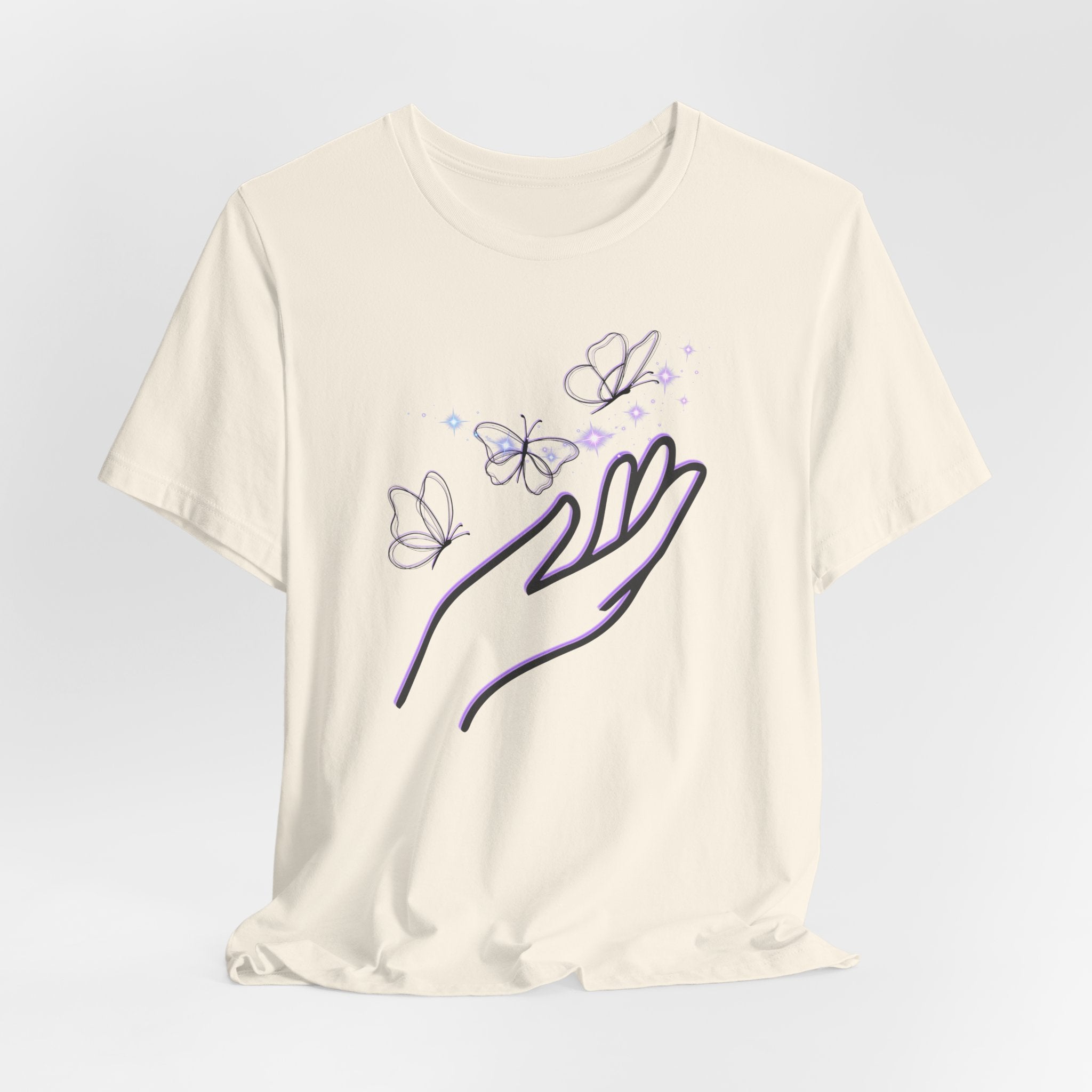 Beige t-shirt with a design of a hand holding butterflies on a light gray background