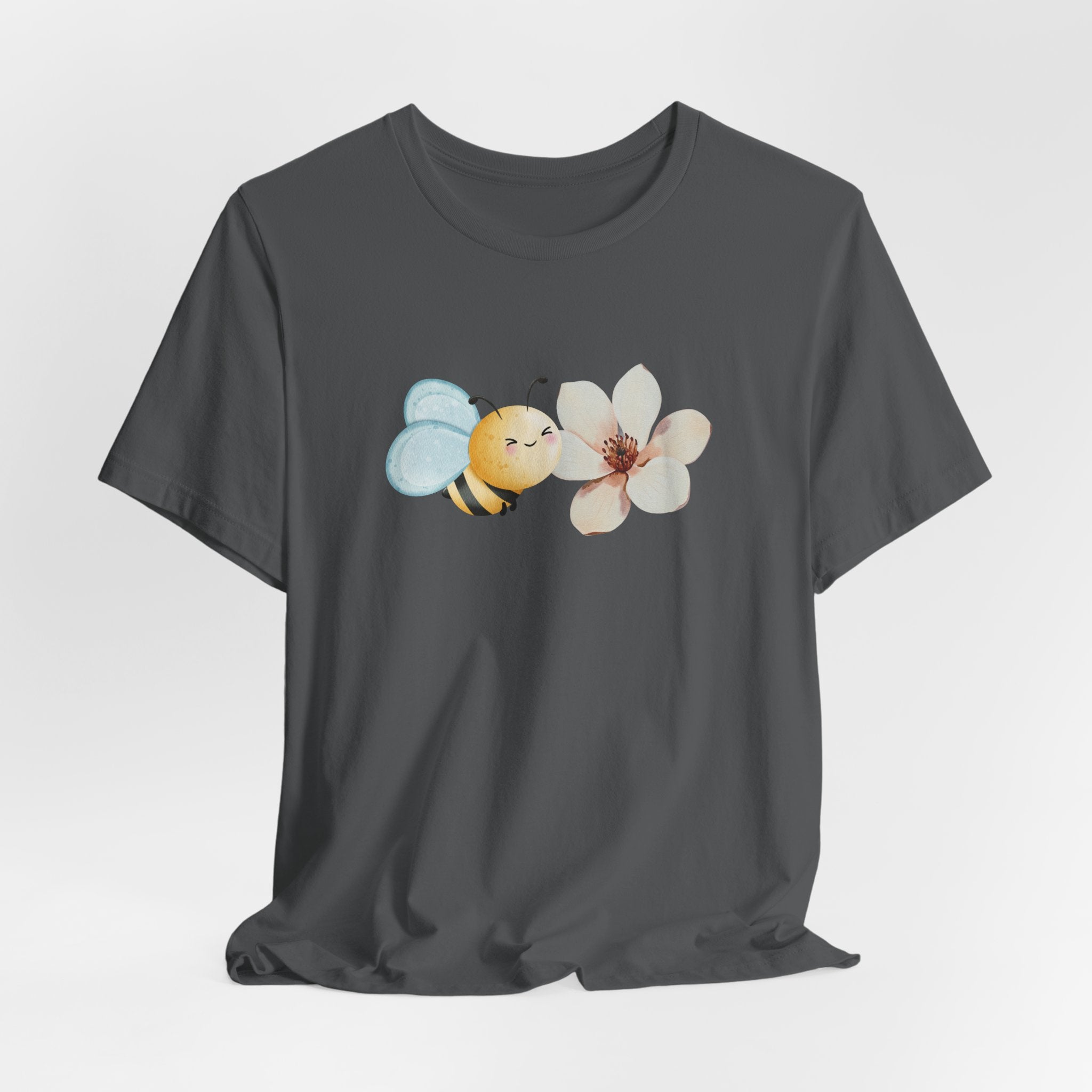 Gray t-shirt with a bee and flower graphic on a light gray background