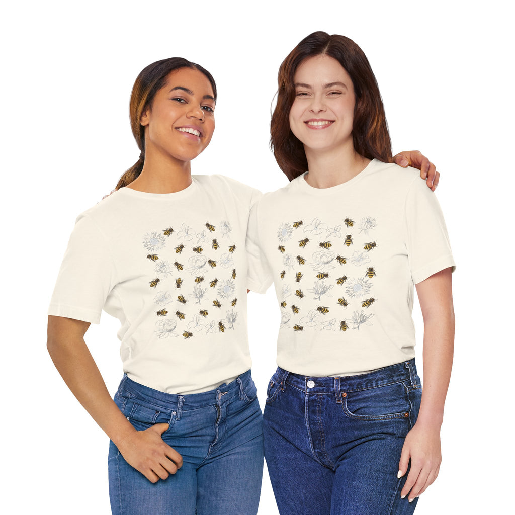 Two women wearing white t-shirts with colorful designs on a white background