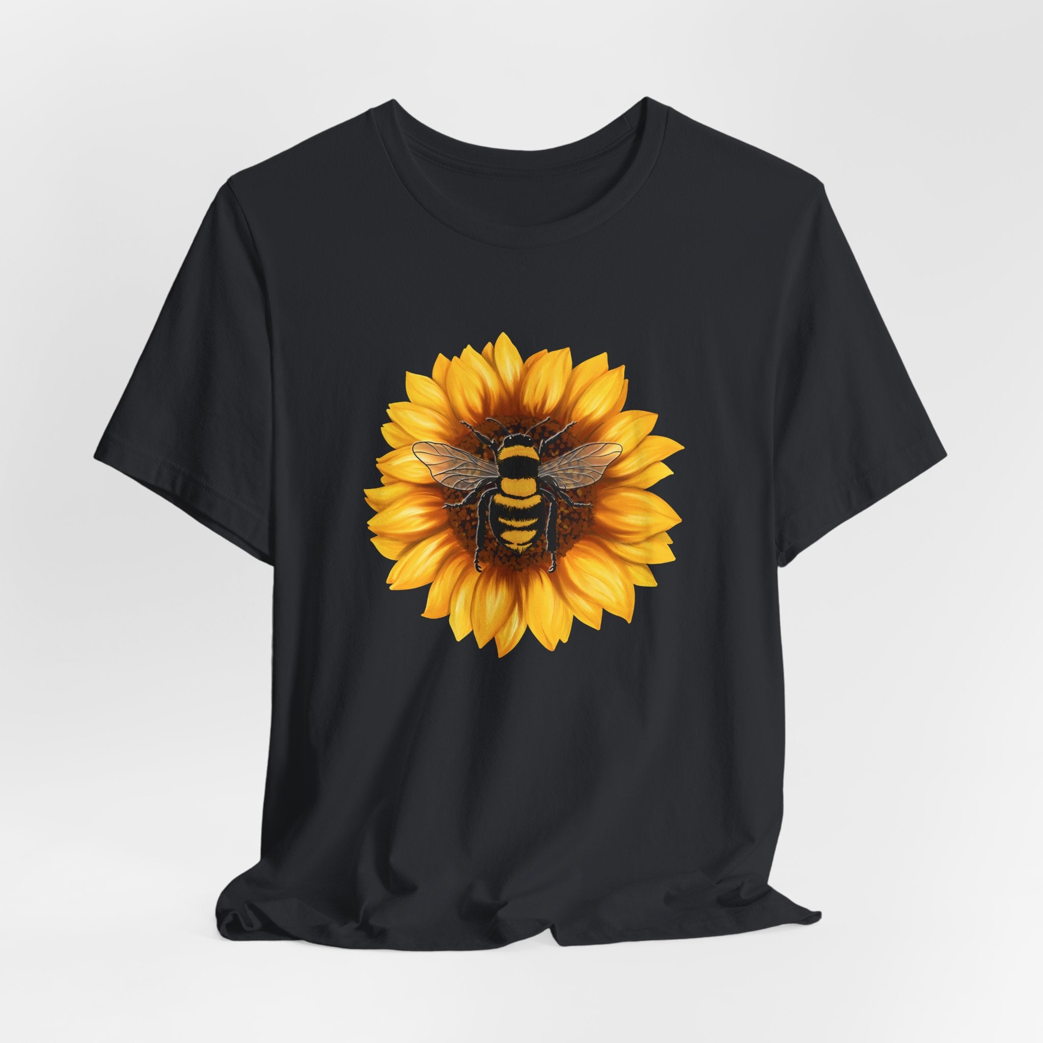 Black t-shirt with a sunflower and bee design on a white background