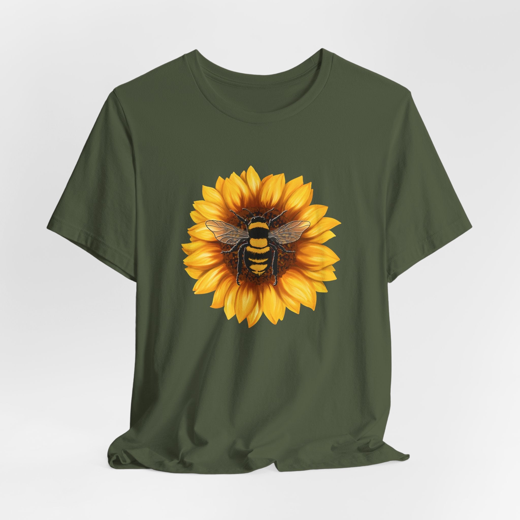 Green t-shirt with a sunflower and bee design on a white background