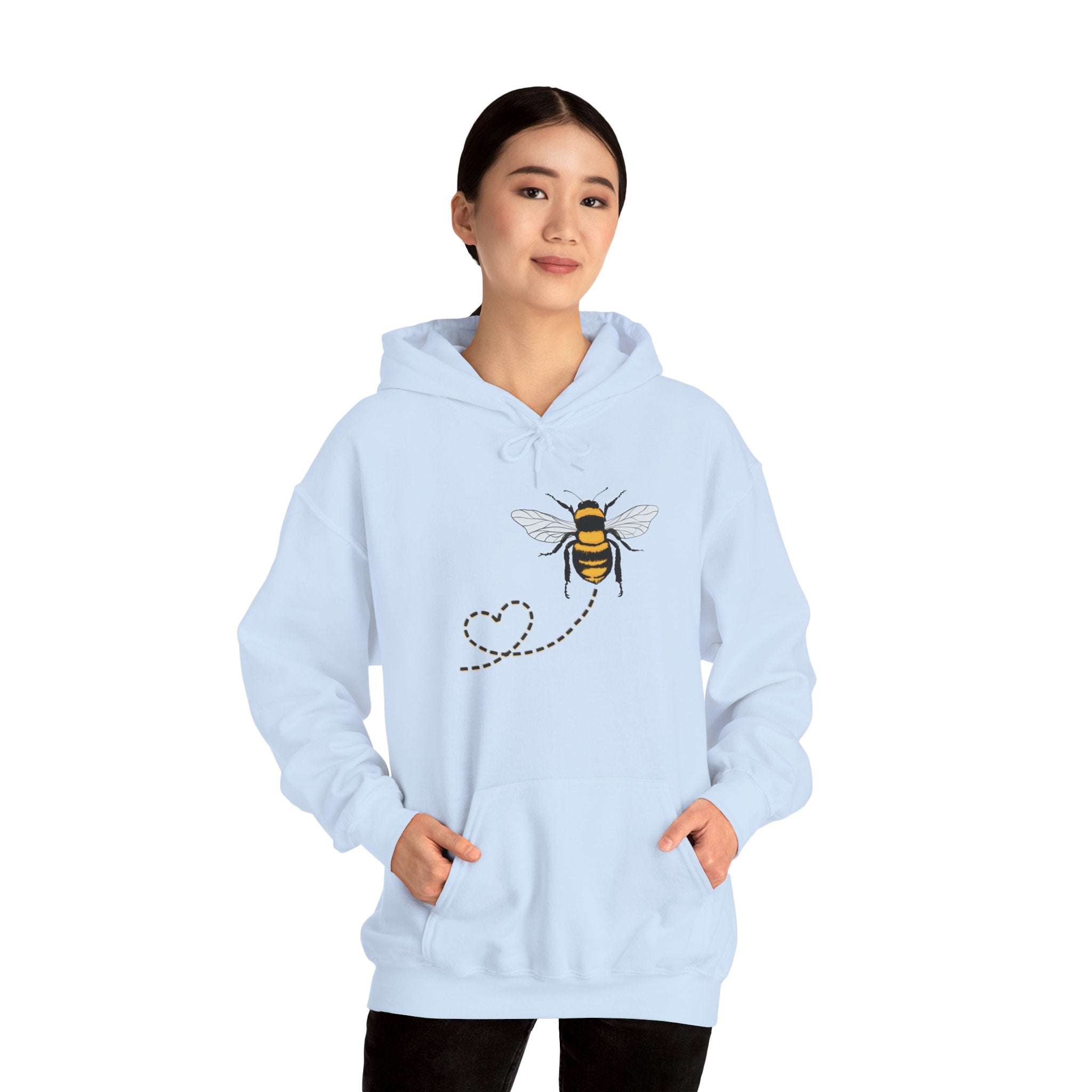 Light blue hoodie with bee design worn by a person on a white background