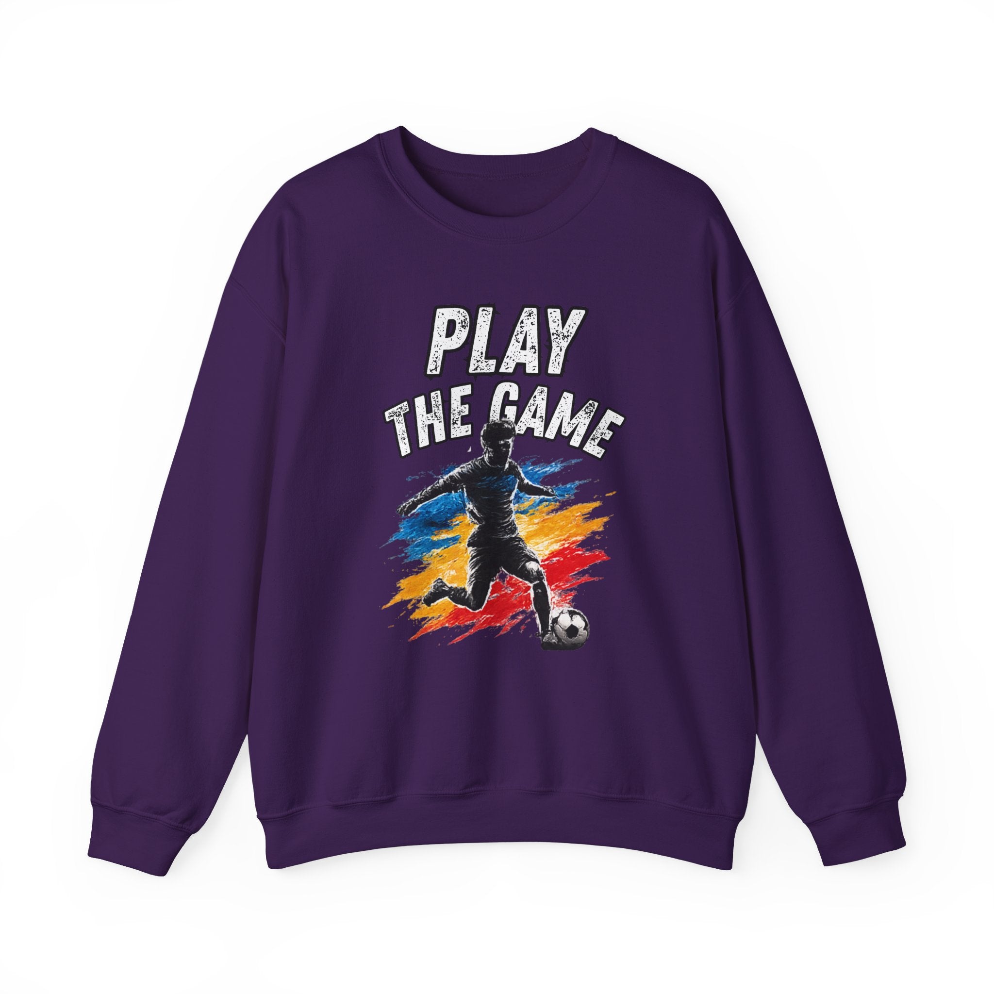 A purple crewneck sweatshirt featuring a graphic of a soccer player kicking a ball with the text 'PLAY THE GAME' in white, set against a plain white background.