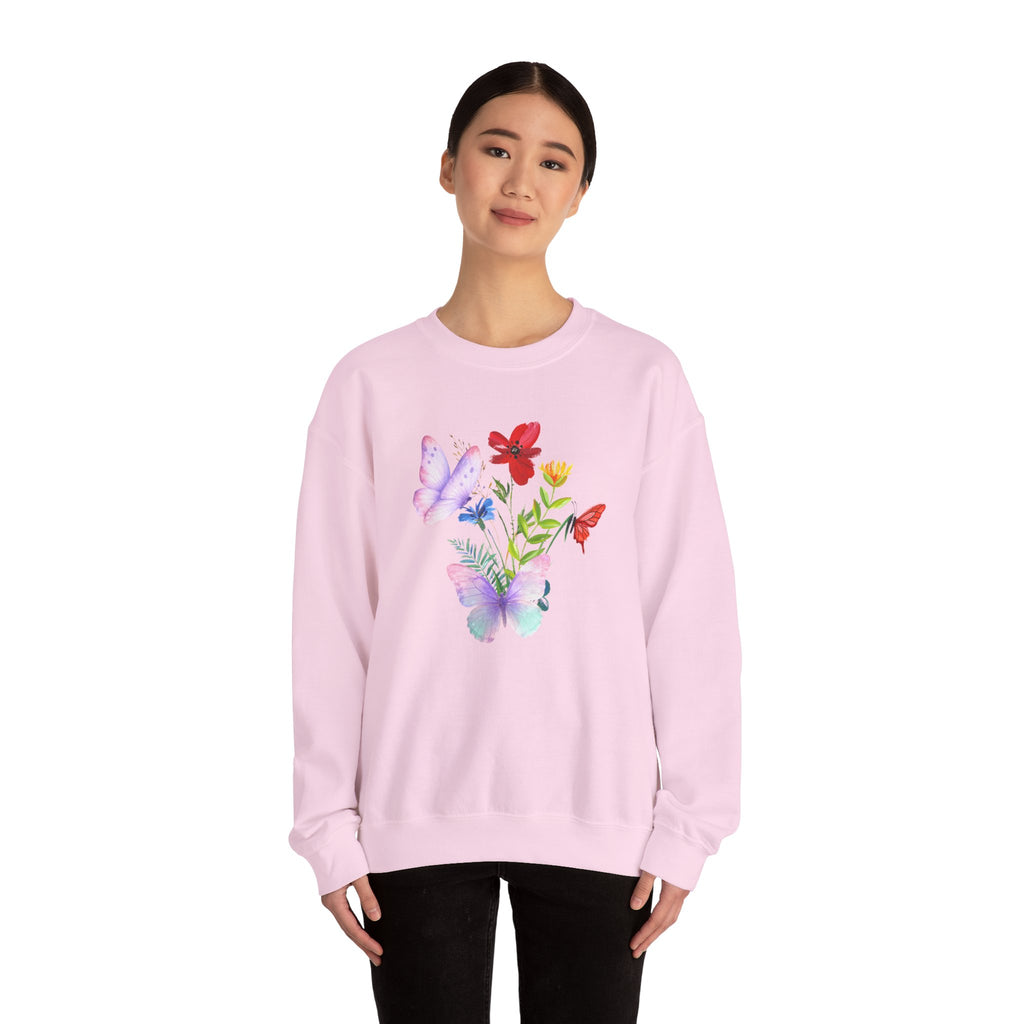 Person wearing a pink sweatshirt with colorful floral design on a white background