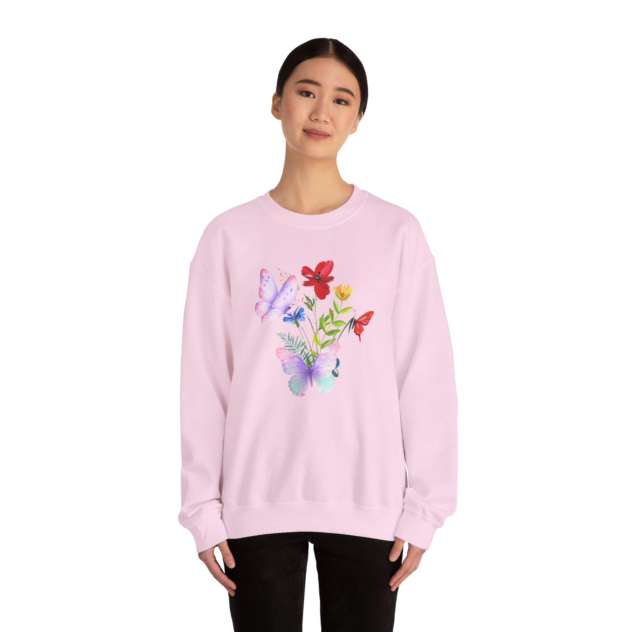 Person wearing a pink sweatshirt with colorful floral design on a white background