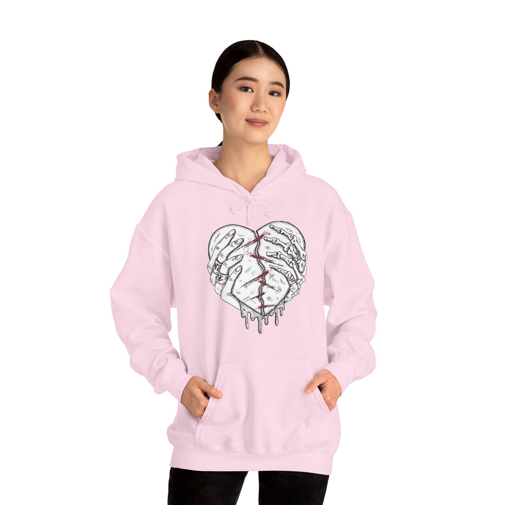Person wearing a pink hoodie with a heart design on a white background