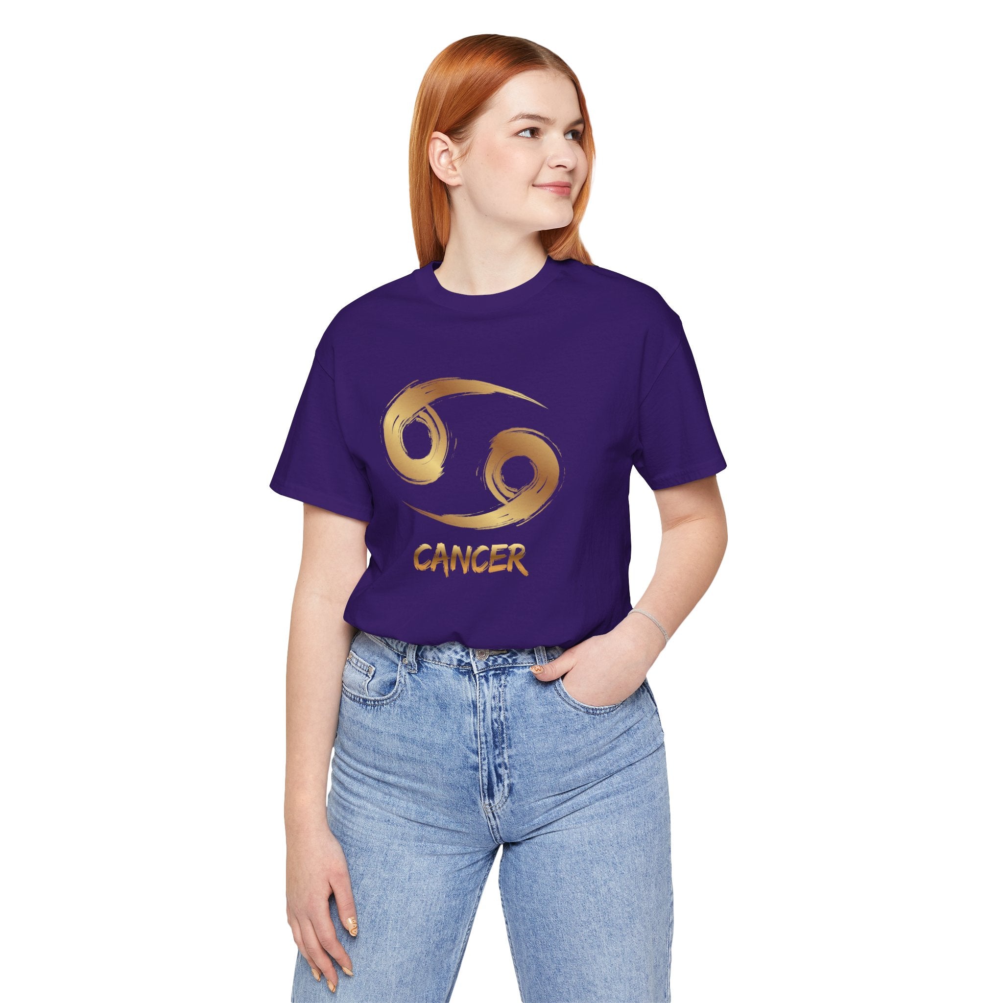 Person wearing a purple t-shirt with a Cancer zodiac symbol on a white background