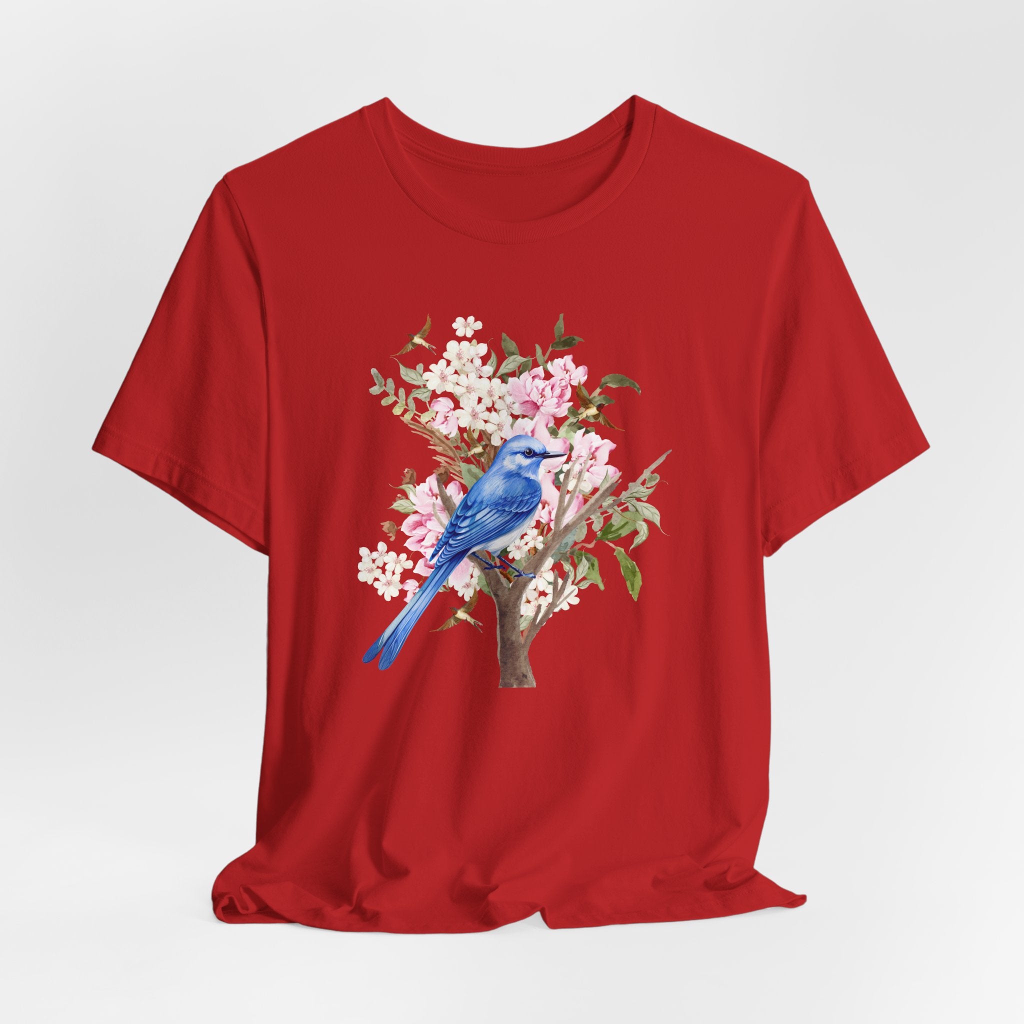 Red t-shirt with a blue bird and floral design on a white background
