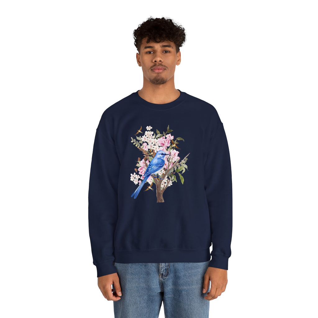 Person wearing a navy blue sweatshirt with a floral and bird design on a white background