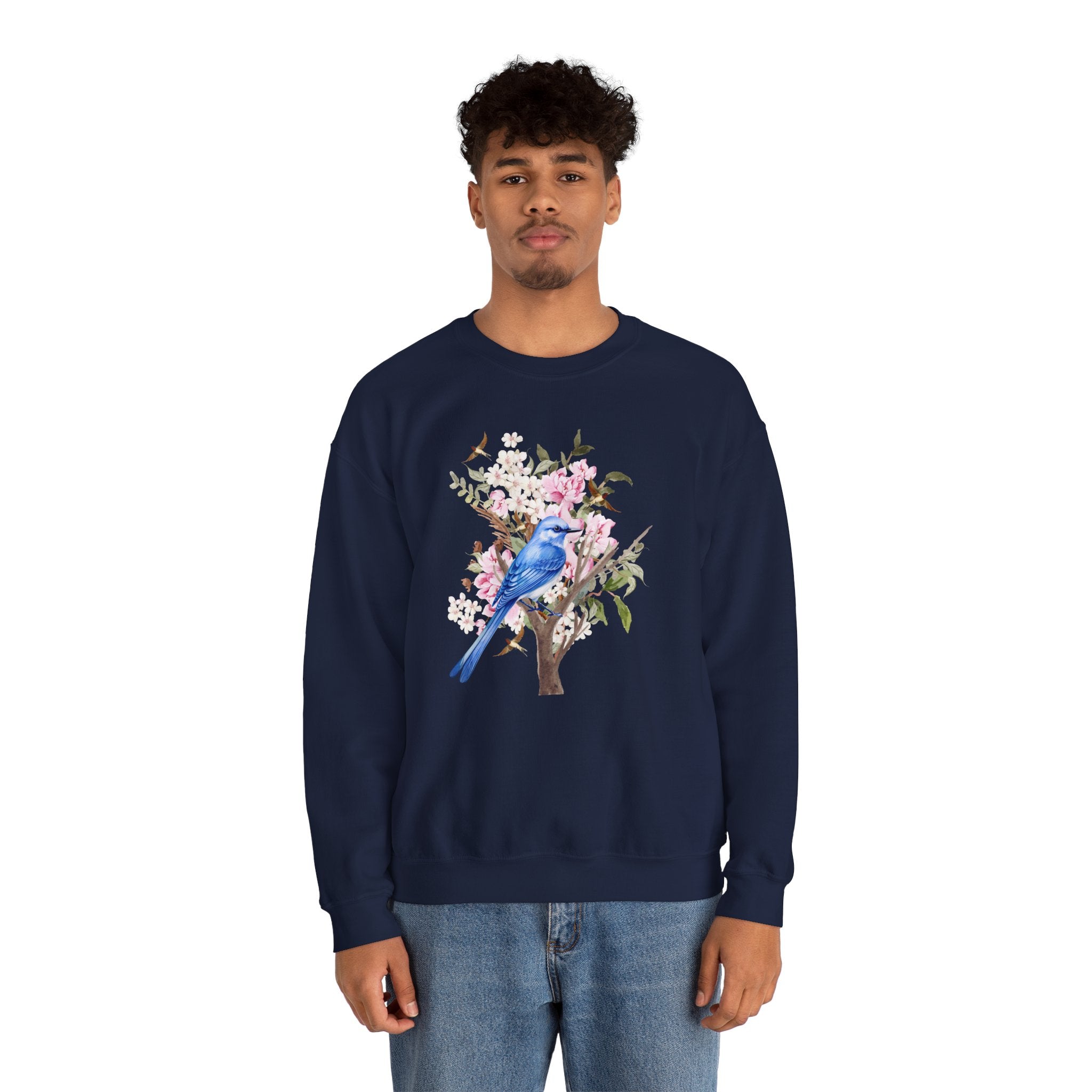 Person wearing a navy blue sweatshirt with a floral and bird design on a white background