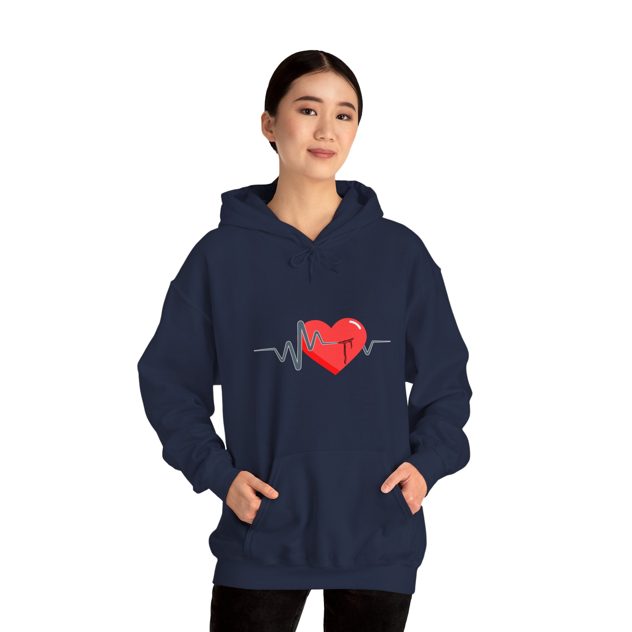Person wearing a navy blue hoodie with a red heart and heartbeat line design on a white background