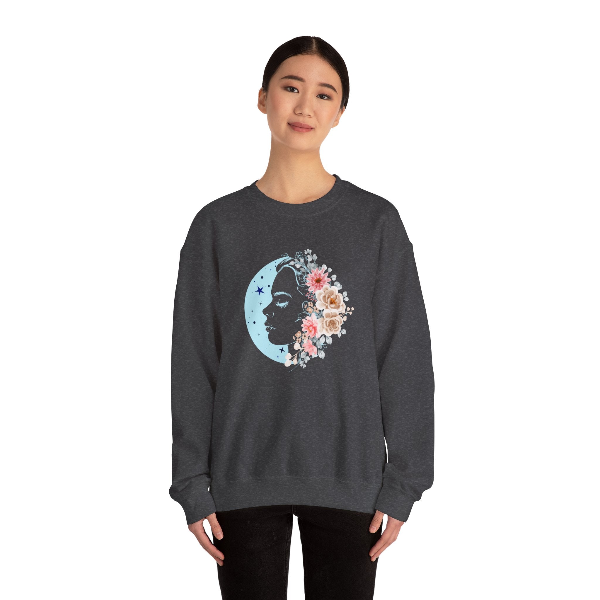Person wearing a dark gray sweatshirt with a floral moon design on a white background