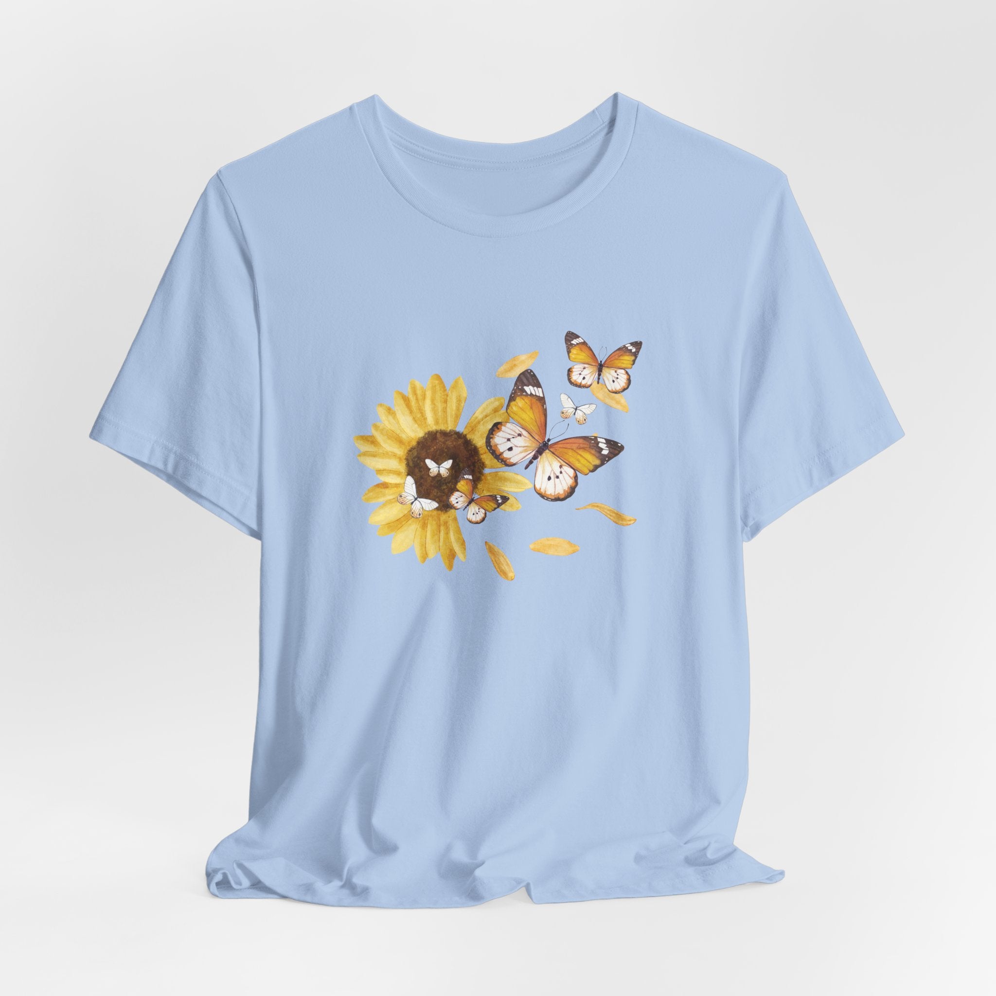 Light blue t-shirt with a sunflower and butterfly graphic on a light gray background
