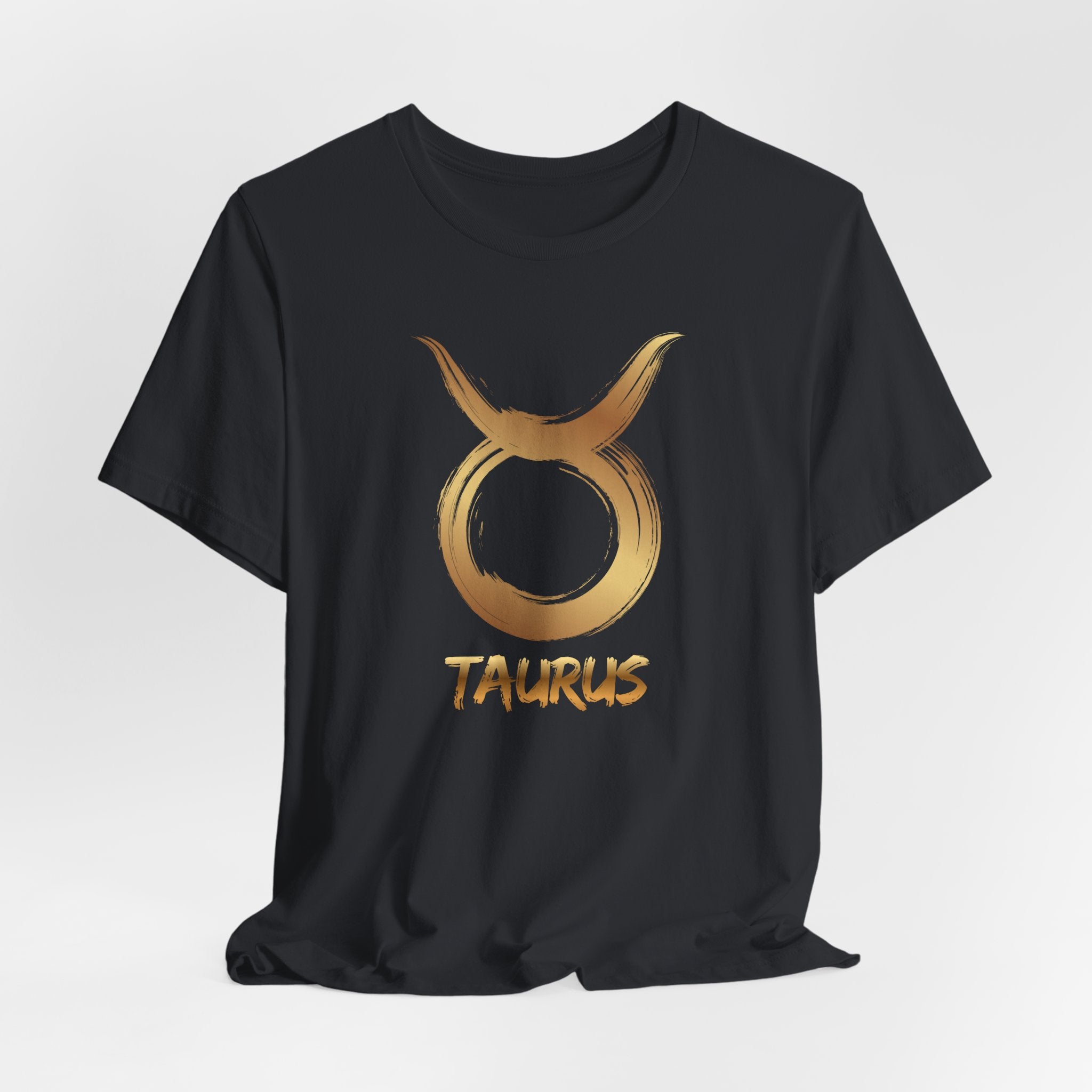 Black t-shirt with gold Taurus zodiac symbol on a white background