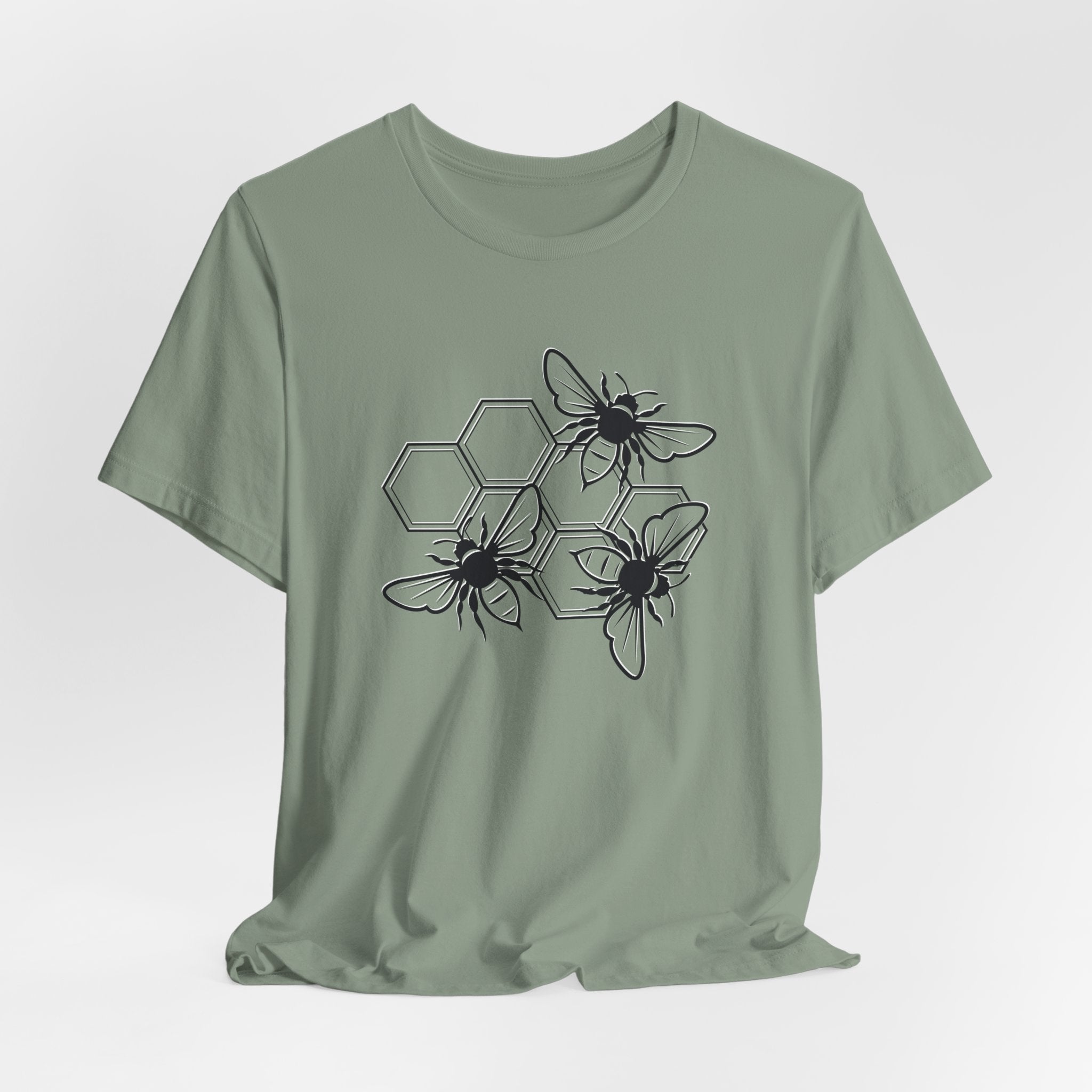 Green t-shirt with bee and honeycomb design on a light gray background