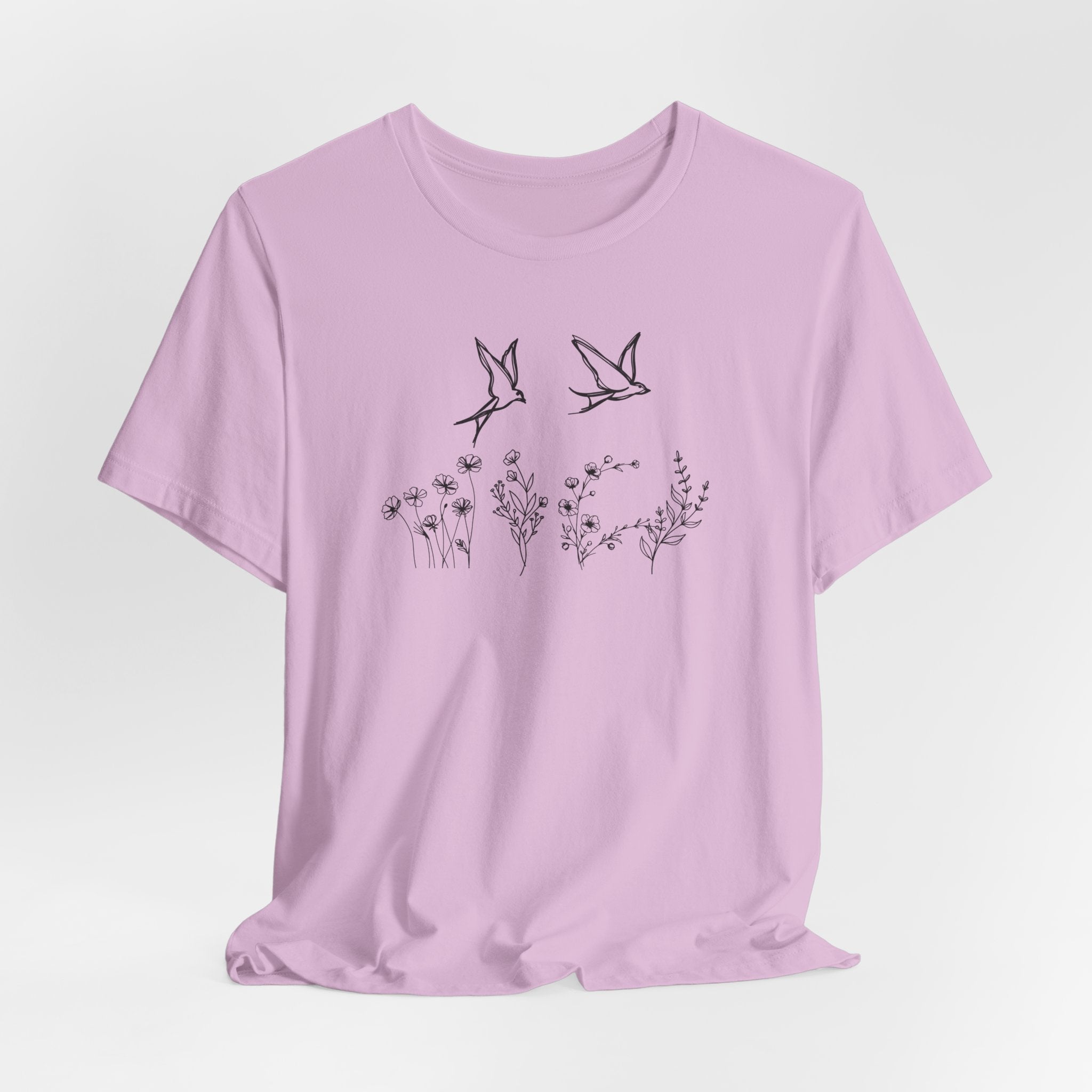 Light purple t-shirt with black bird and floral design on a light gray background