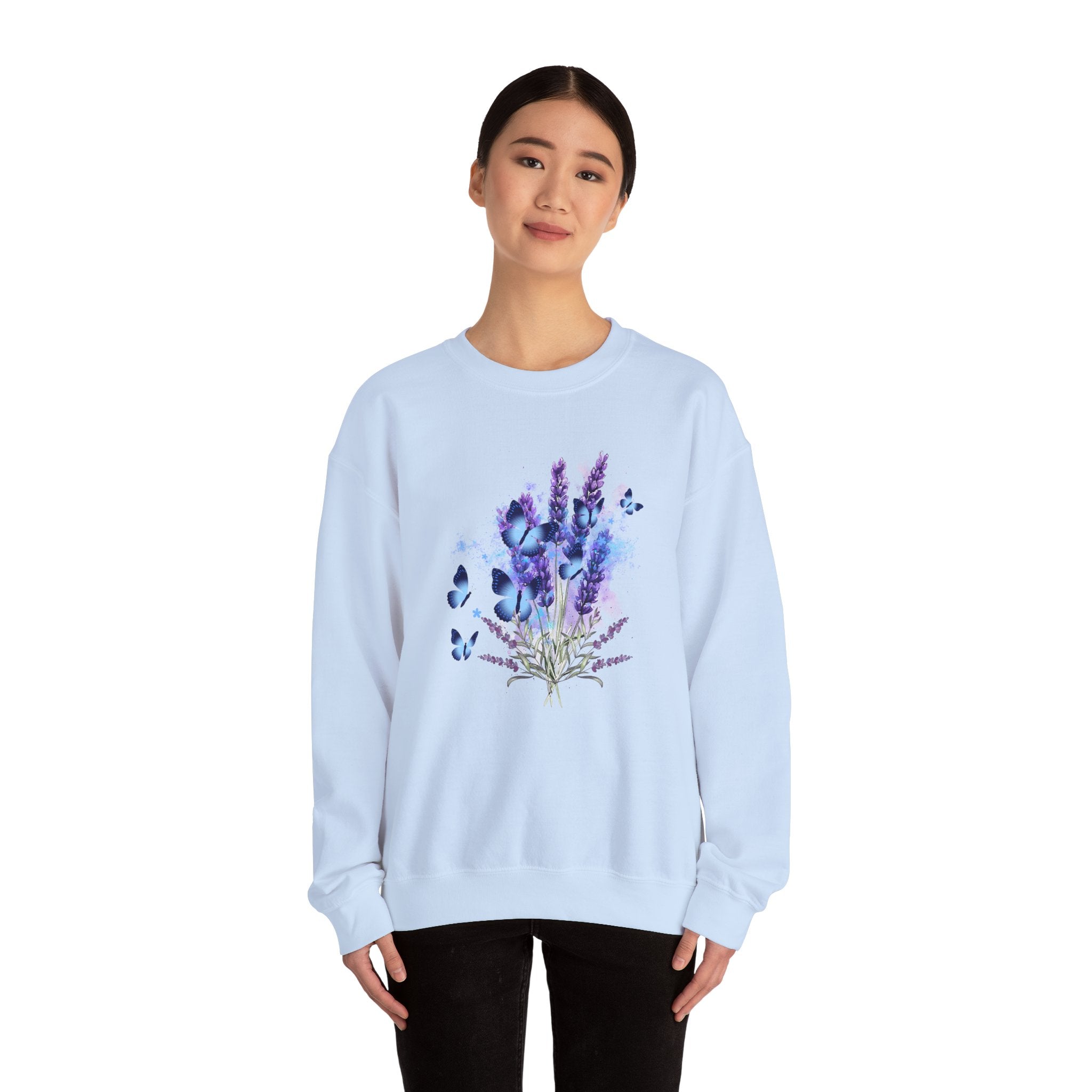 Light blue sweatshirt with floral design worn by a person on a white background