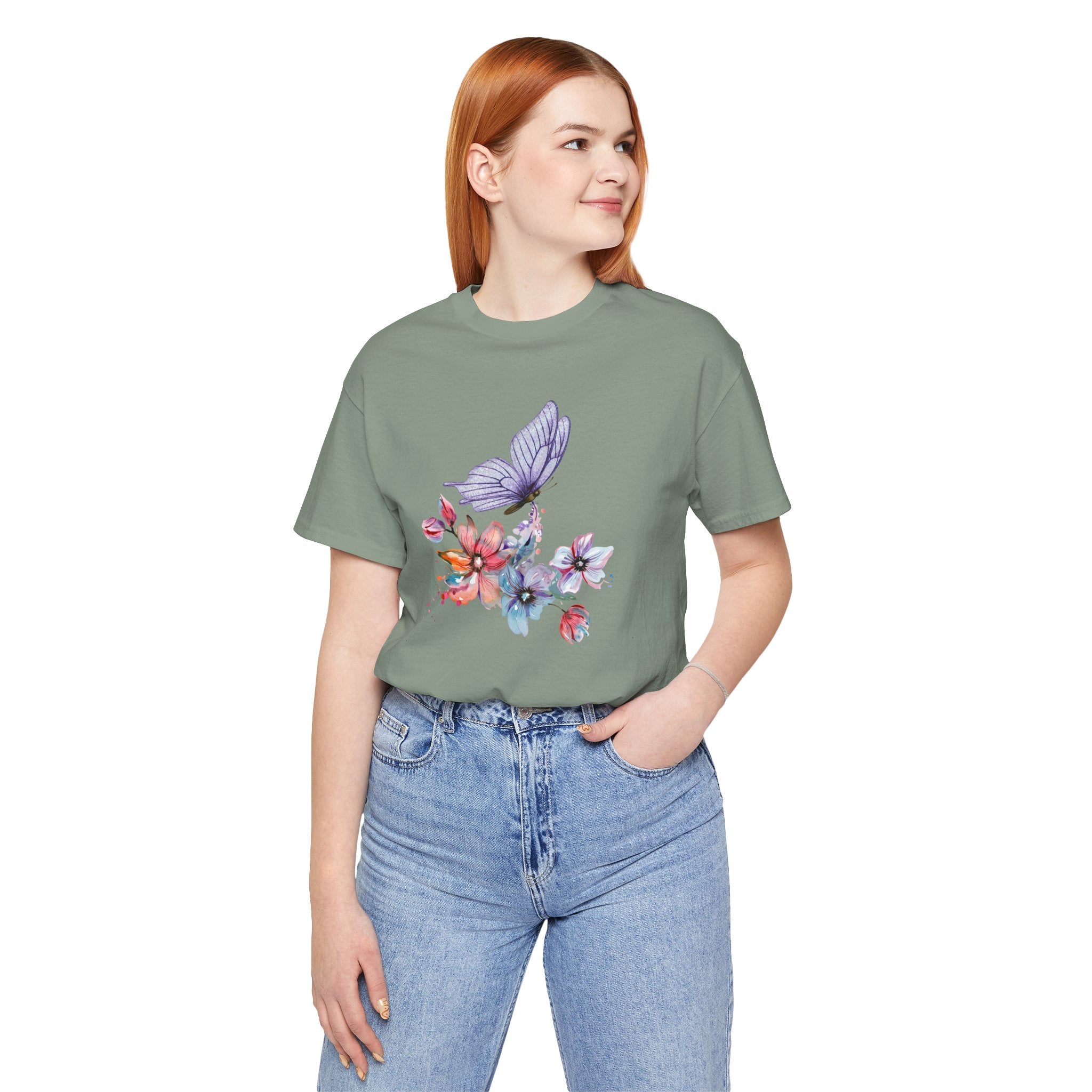 Person wearing a green t-shirt with a floral and butterfly design on a white background