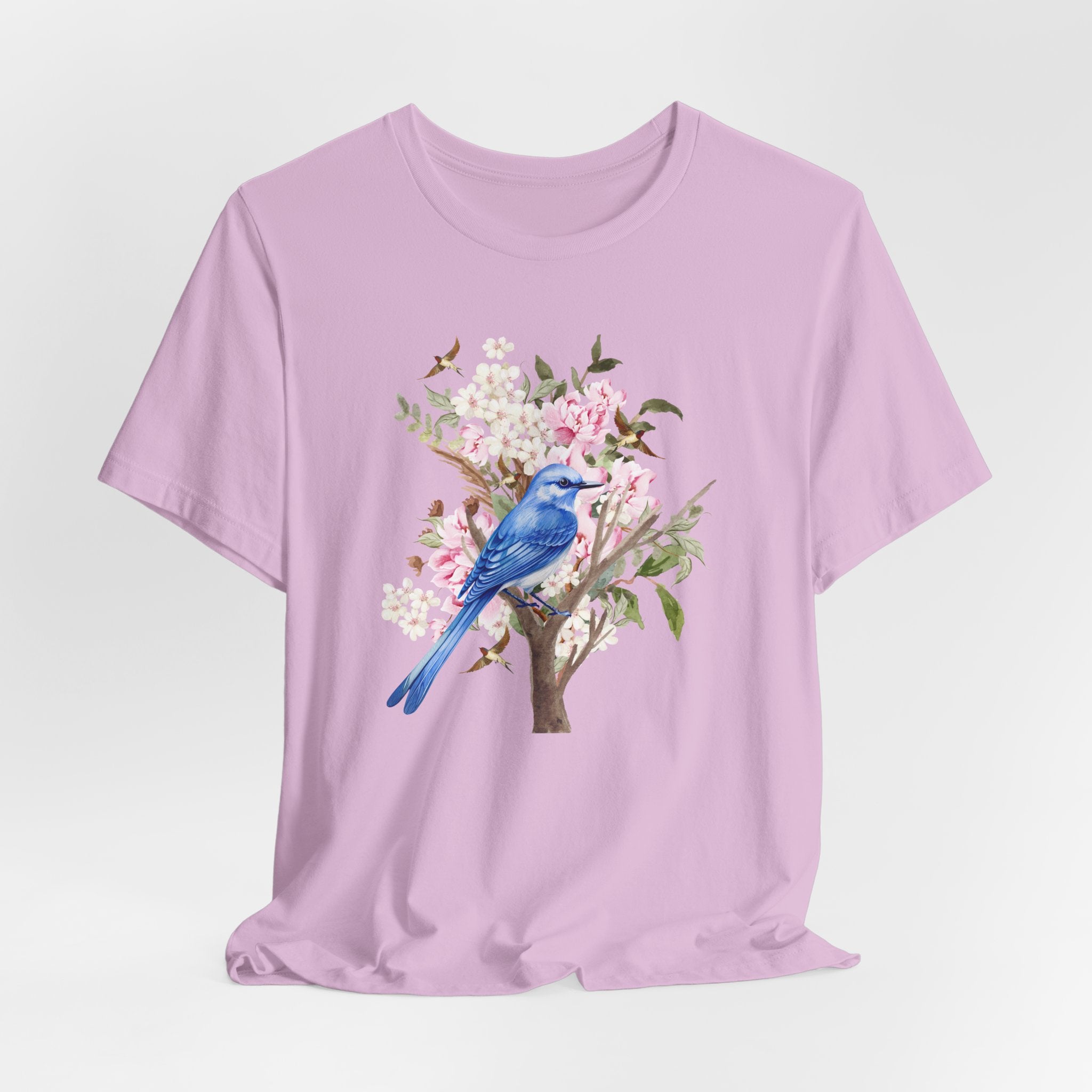 Purple t-shirt with a blue bird and floral design on a light gray background