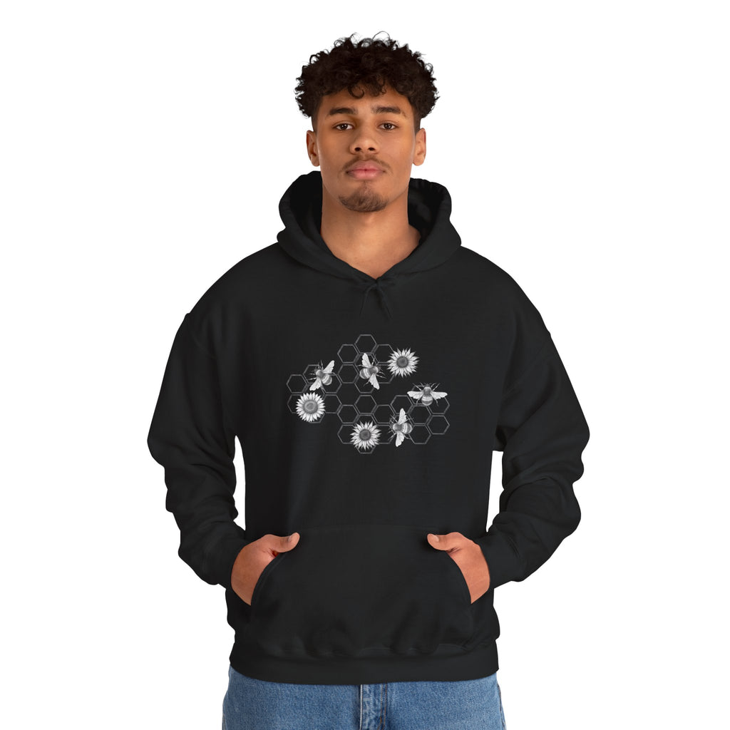 Person wearing a black hoodie with a graphic design on a white background