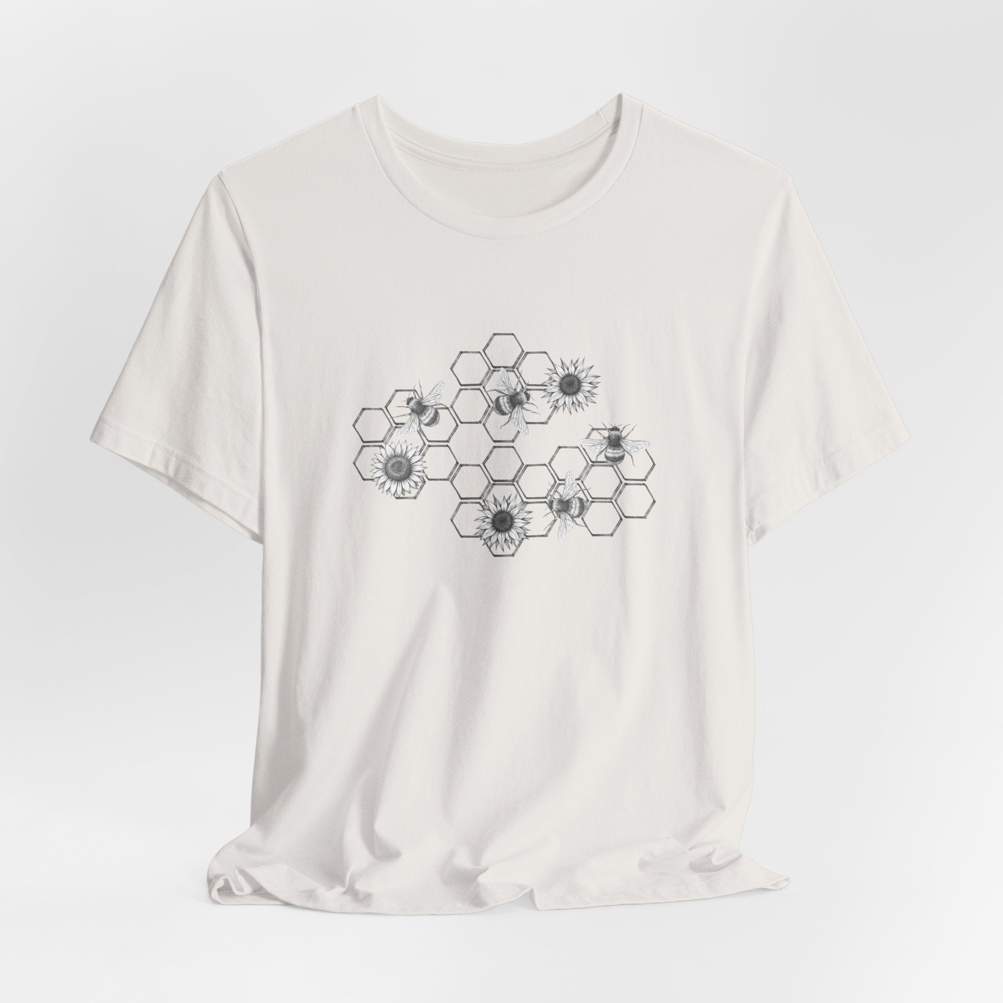 White t-shirt with black geometric flower pattern on a light gray background