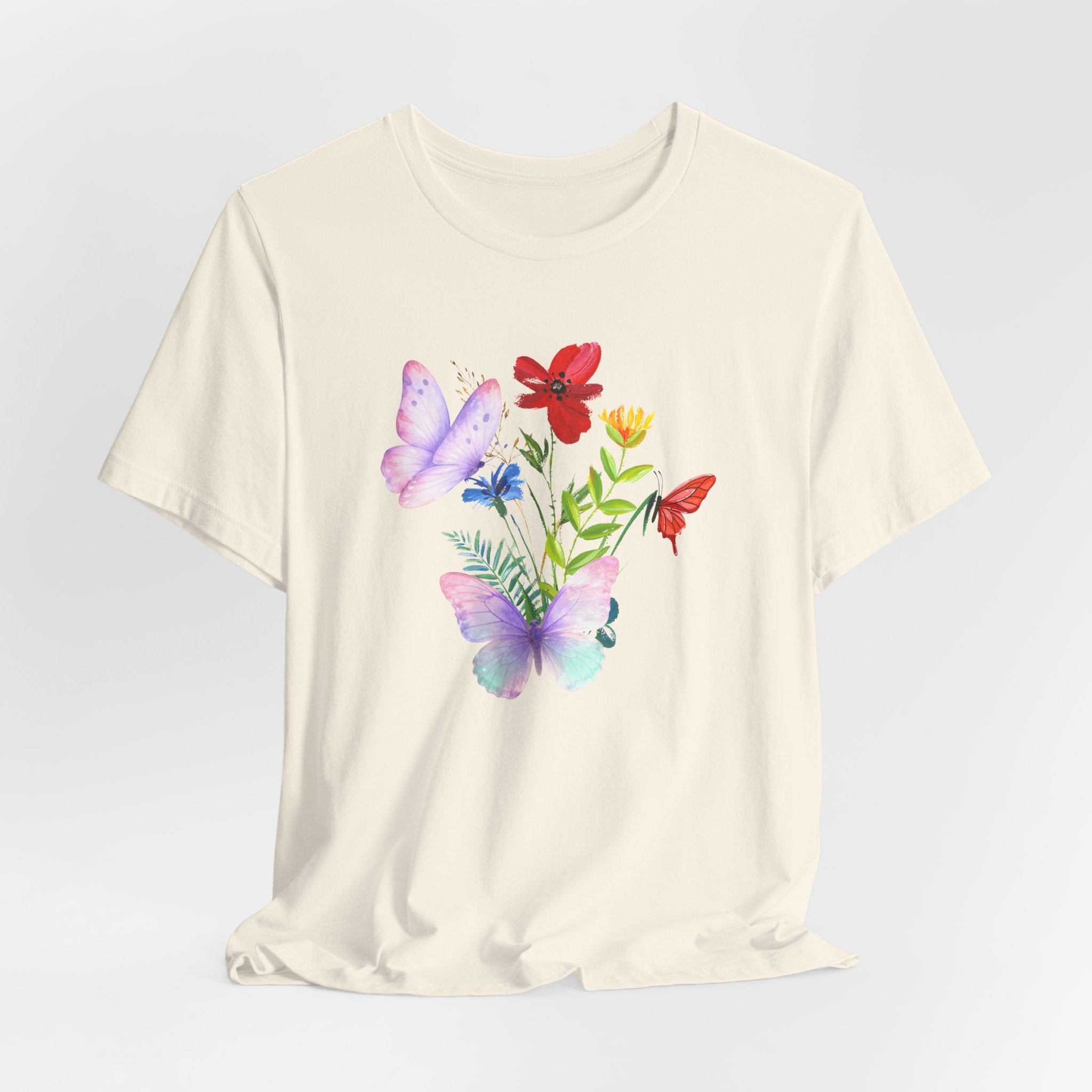 Beige t-shirt with colorful butterfly and flower design on a light gray background