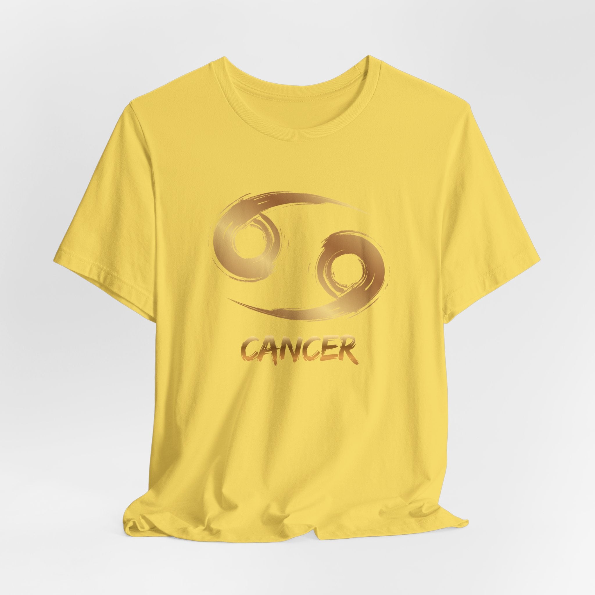 Yellow t-shirt with Cancer zodiac symbol on a light gray background