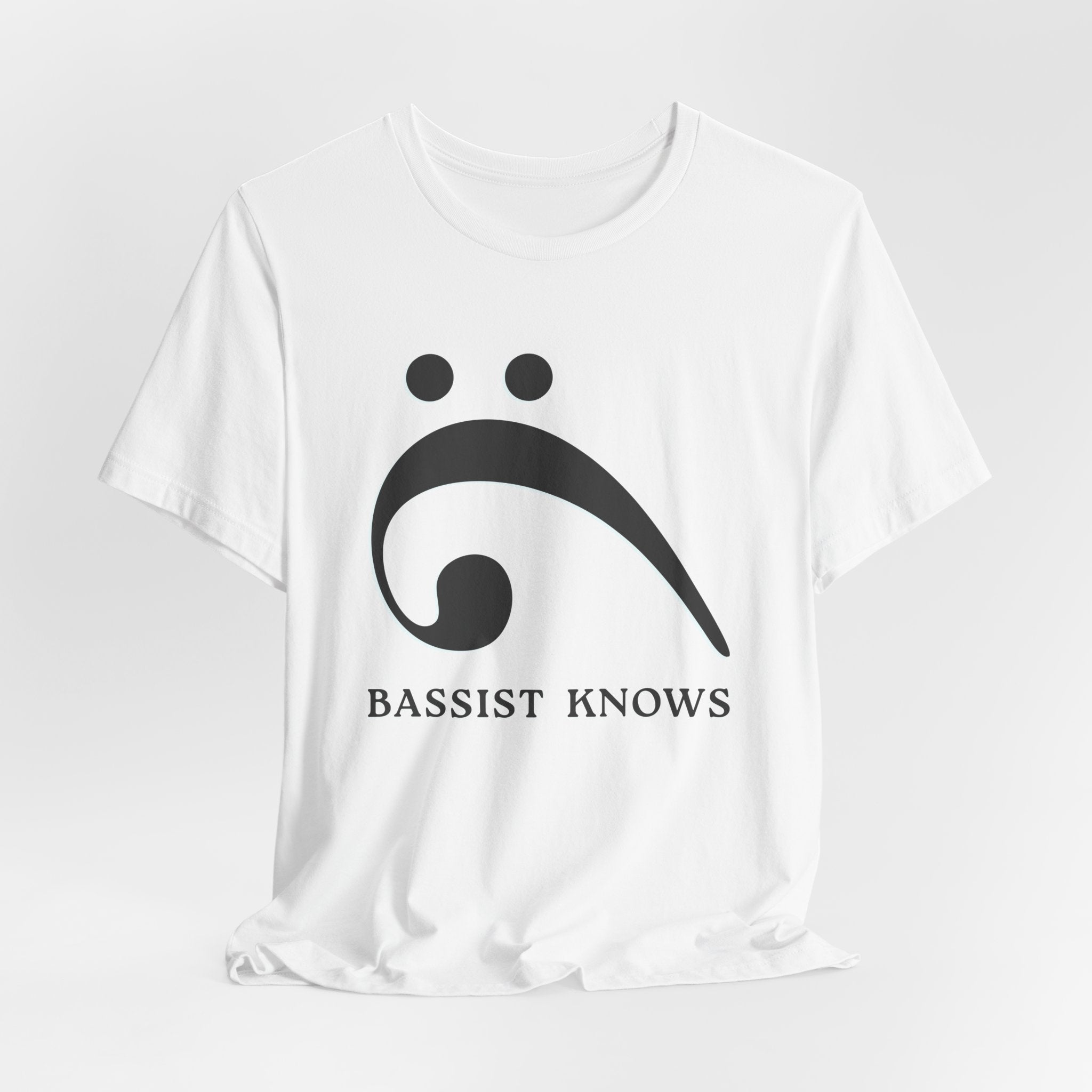 White t-shirt with black bass clef and 'Bassist Knows' text on a light gray background