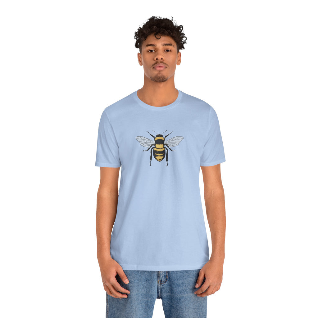 Person wearing a light blue t-shirt with a bee design on a white background