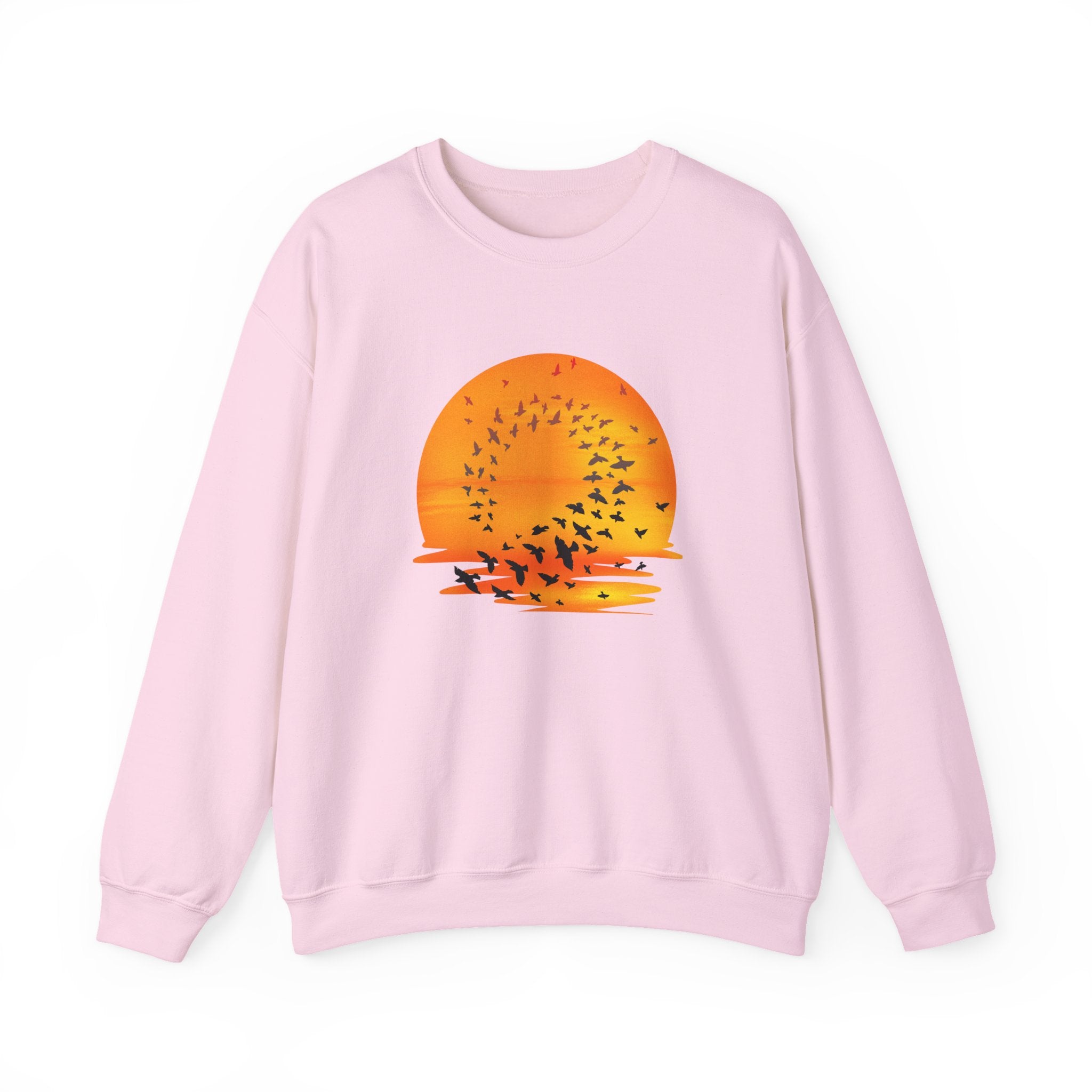 Pink sweatshirt with a sunset and bird design on a white background