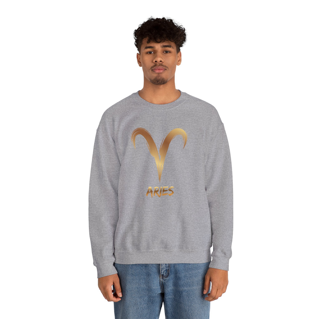 Person wearing a gray sweatshirt with a gold Aries symbol on a white background