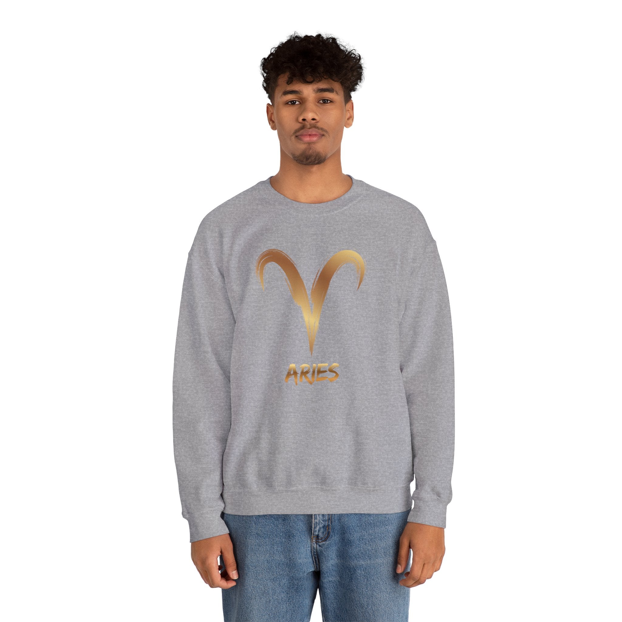 Person wearing a gray sweatshirt with a gold Aries symbol on a white background