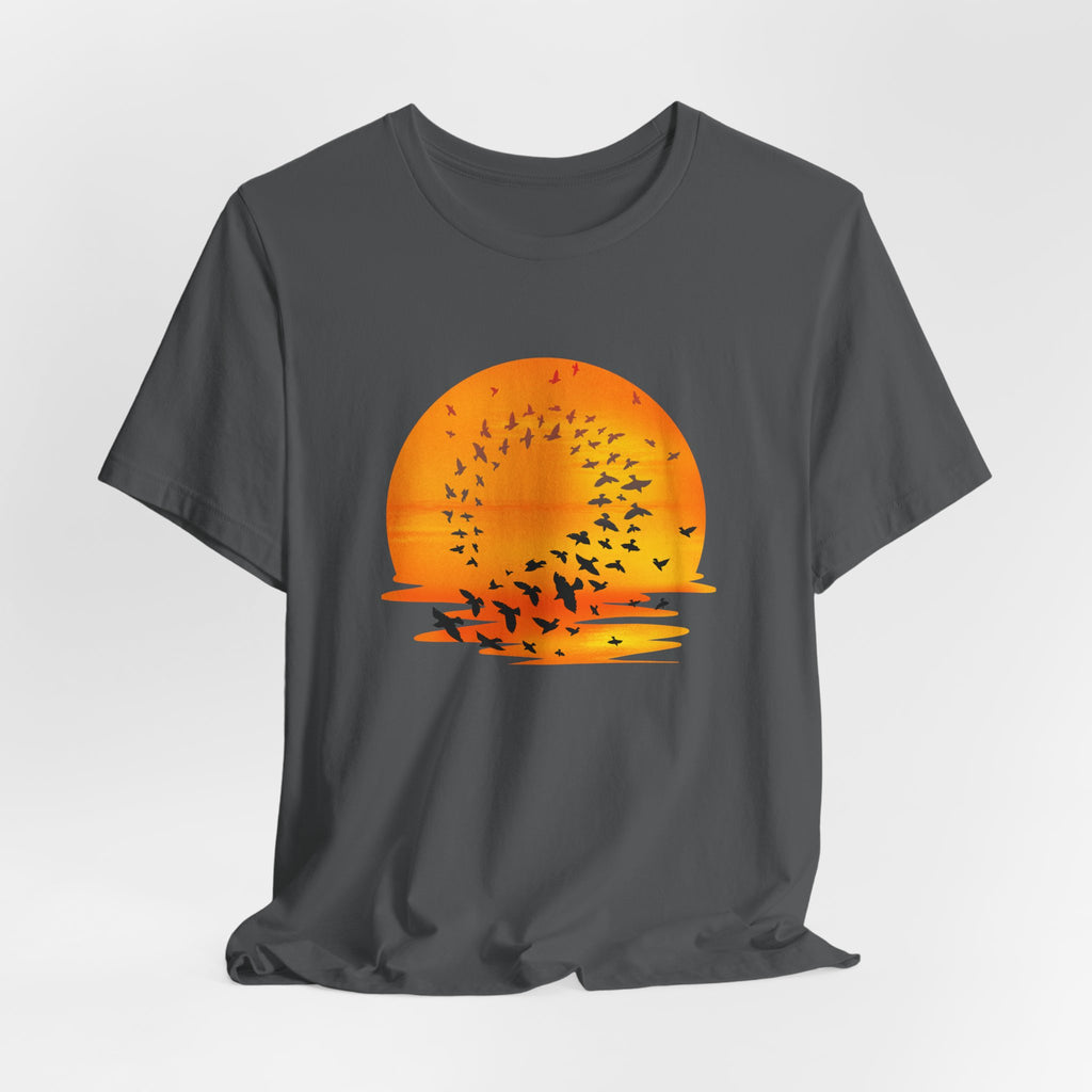 Gray t-shirt with an orange sunset and bird graphic on a light gray background