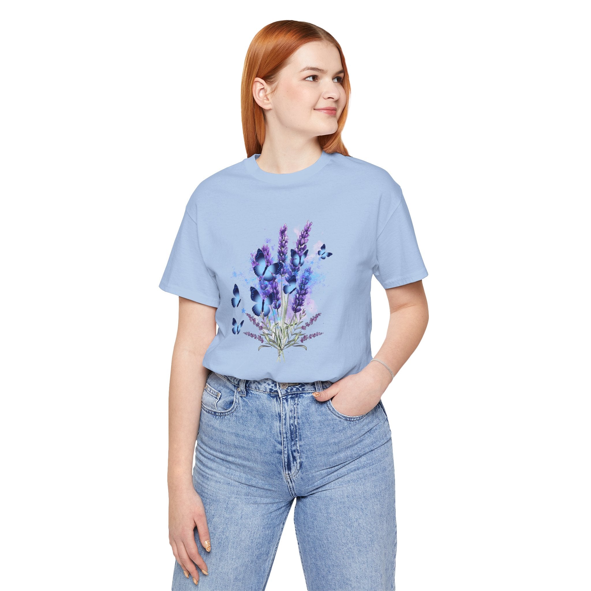 Person wearing a light blue t-shirt with floral design on a white background