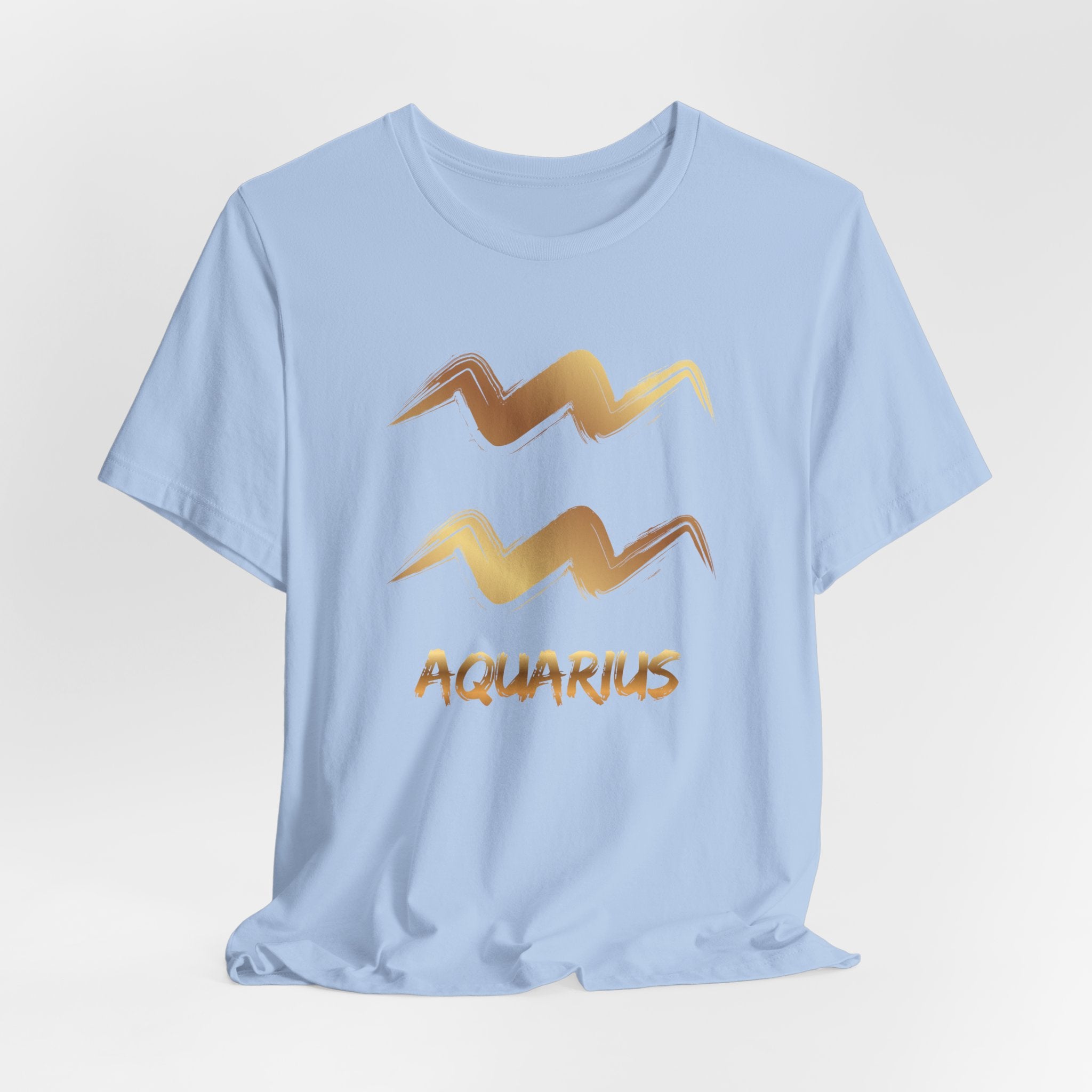 Light blue t-shirt with gold Aquarius zodiac sign design on a light gray background