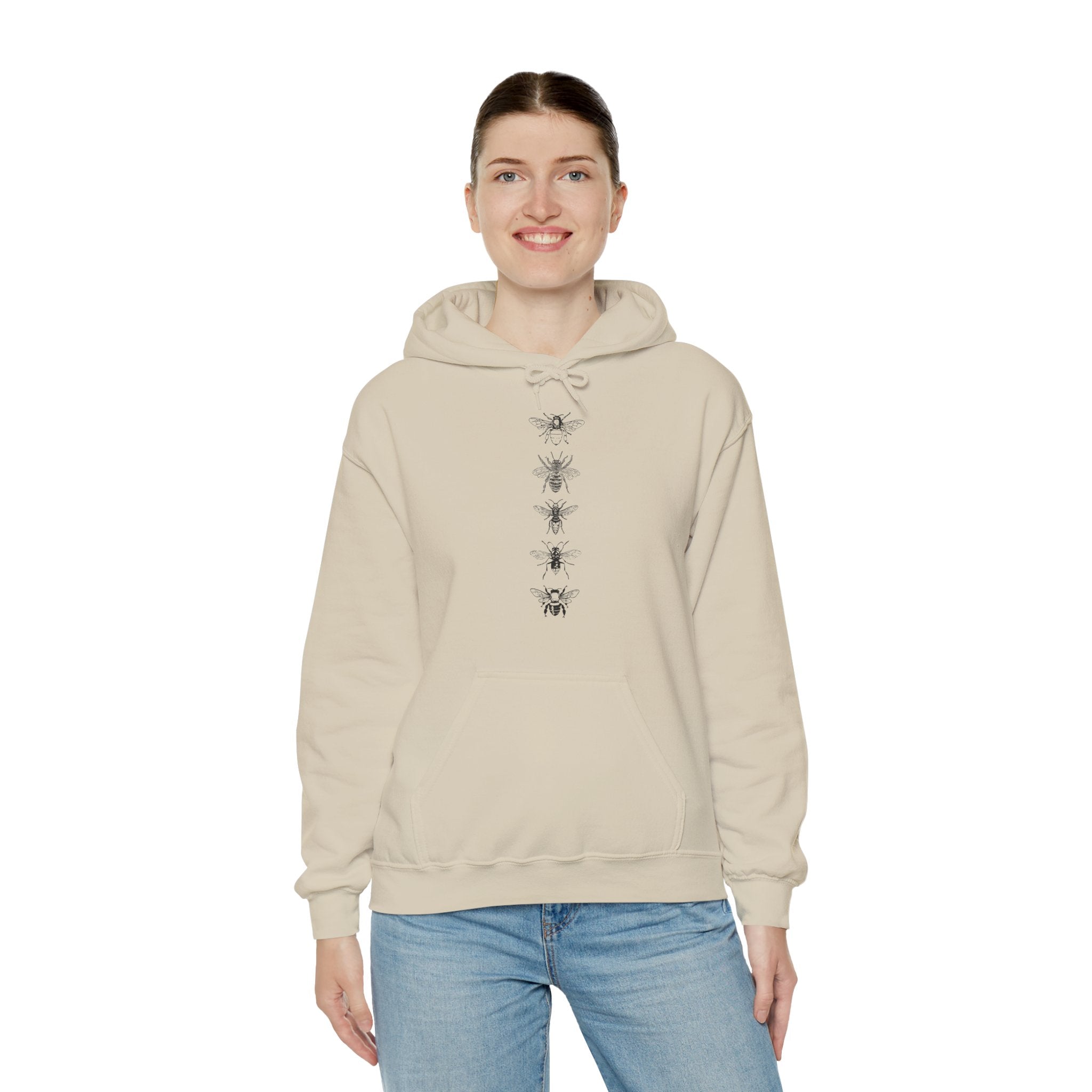 Person wearing a beige hoodie with a bee design on a white background