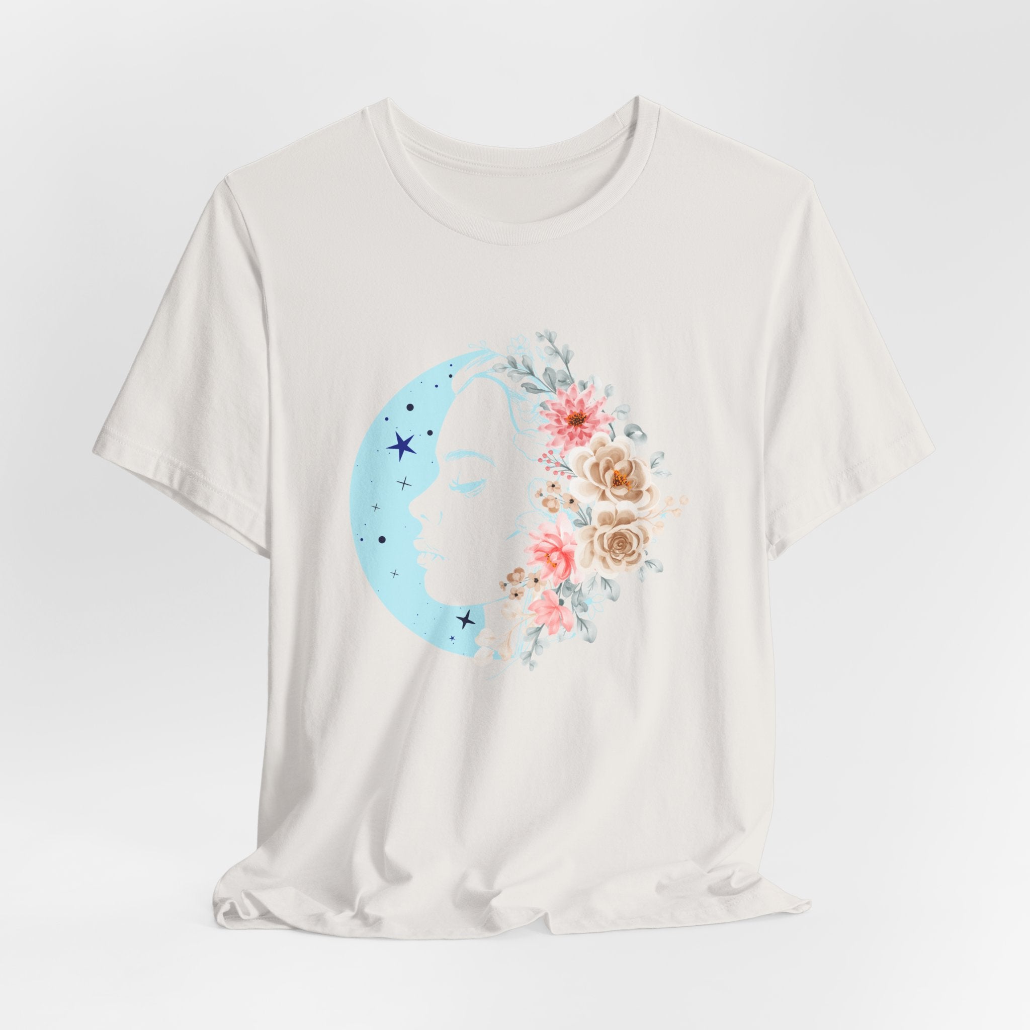 White t-shirt with a blue crescent moon and floral design on a light gray background
